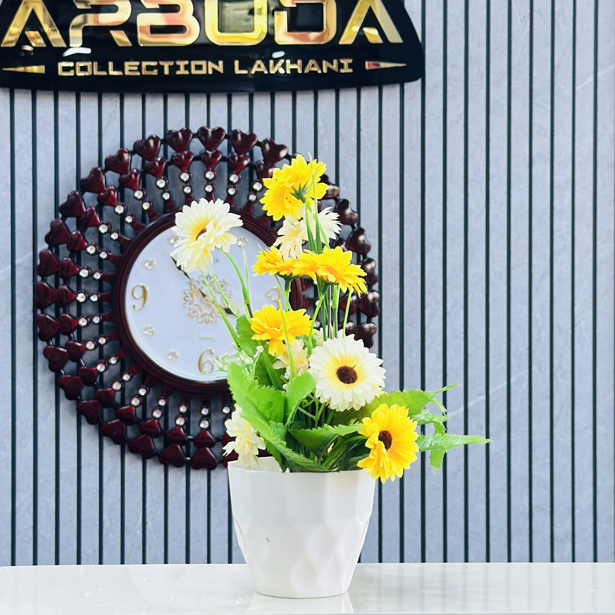 Sunflower arrangement in a white ceramic pot.