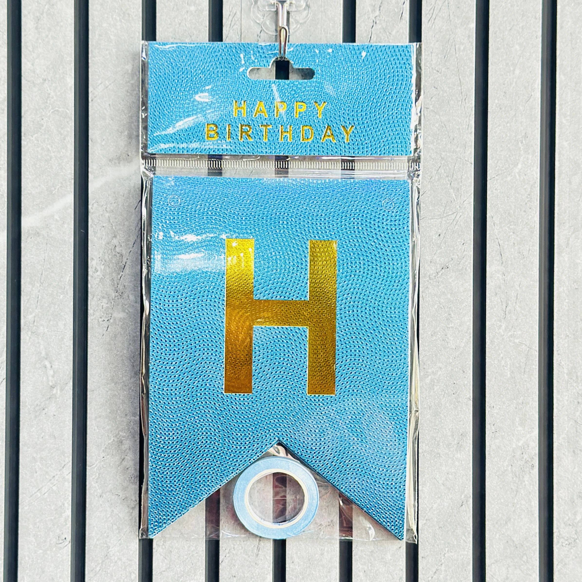 Blue paper Happy Birthday bunting banner with shiny gold foil lettering