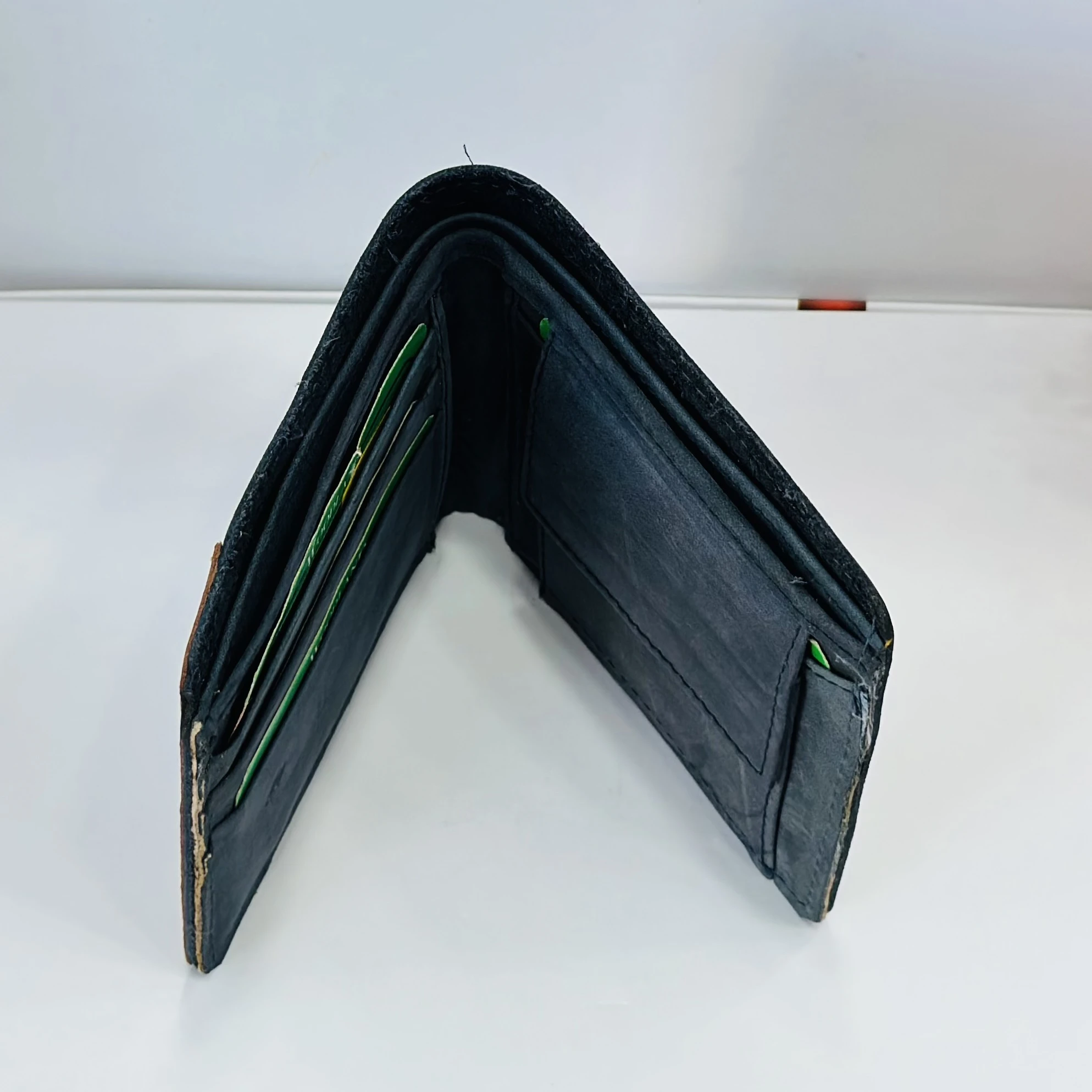 Woodland men's leather bi-fold wallet in a black and beige color block design.