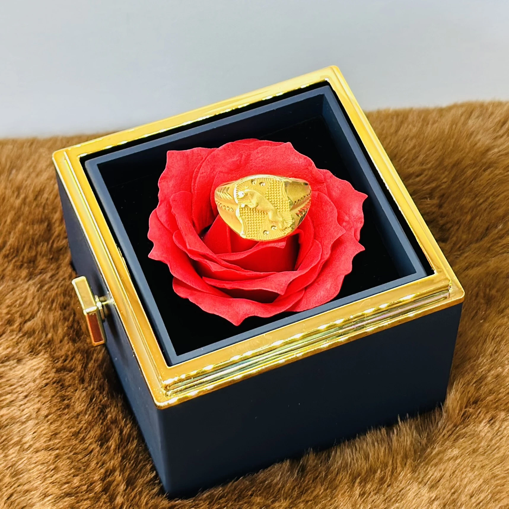 Gold toned men's ring with an embossed design