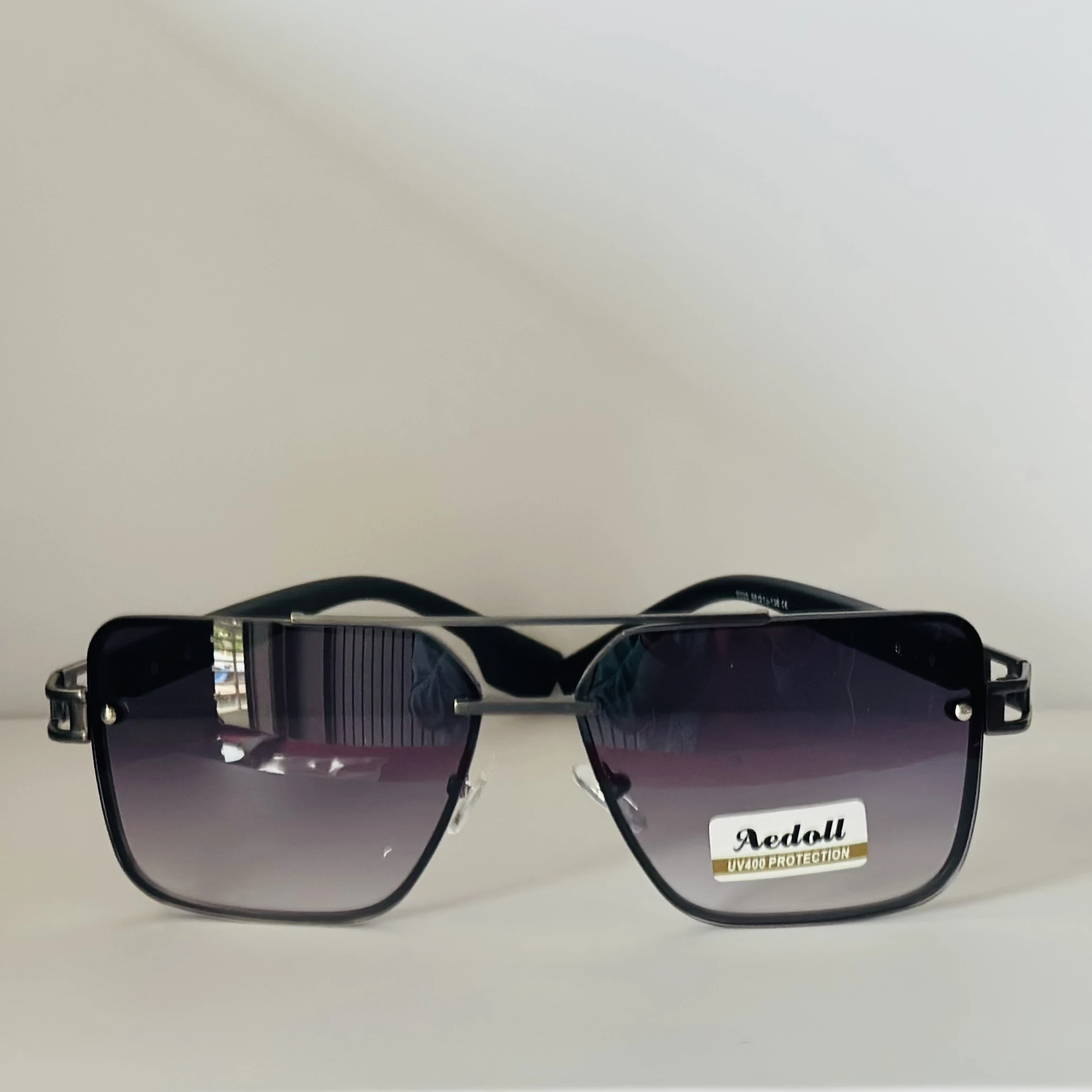 pair of Aedoll Goggle sunglasses with a gold metal frame and pink gradient lenses.