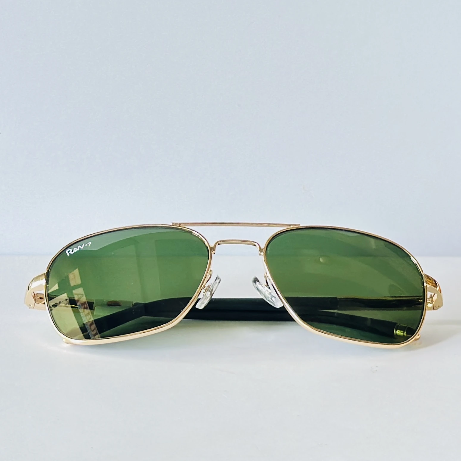 appear to be retro square or aviator-style sunglasses