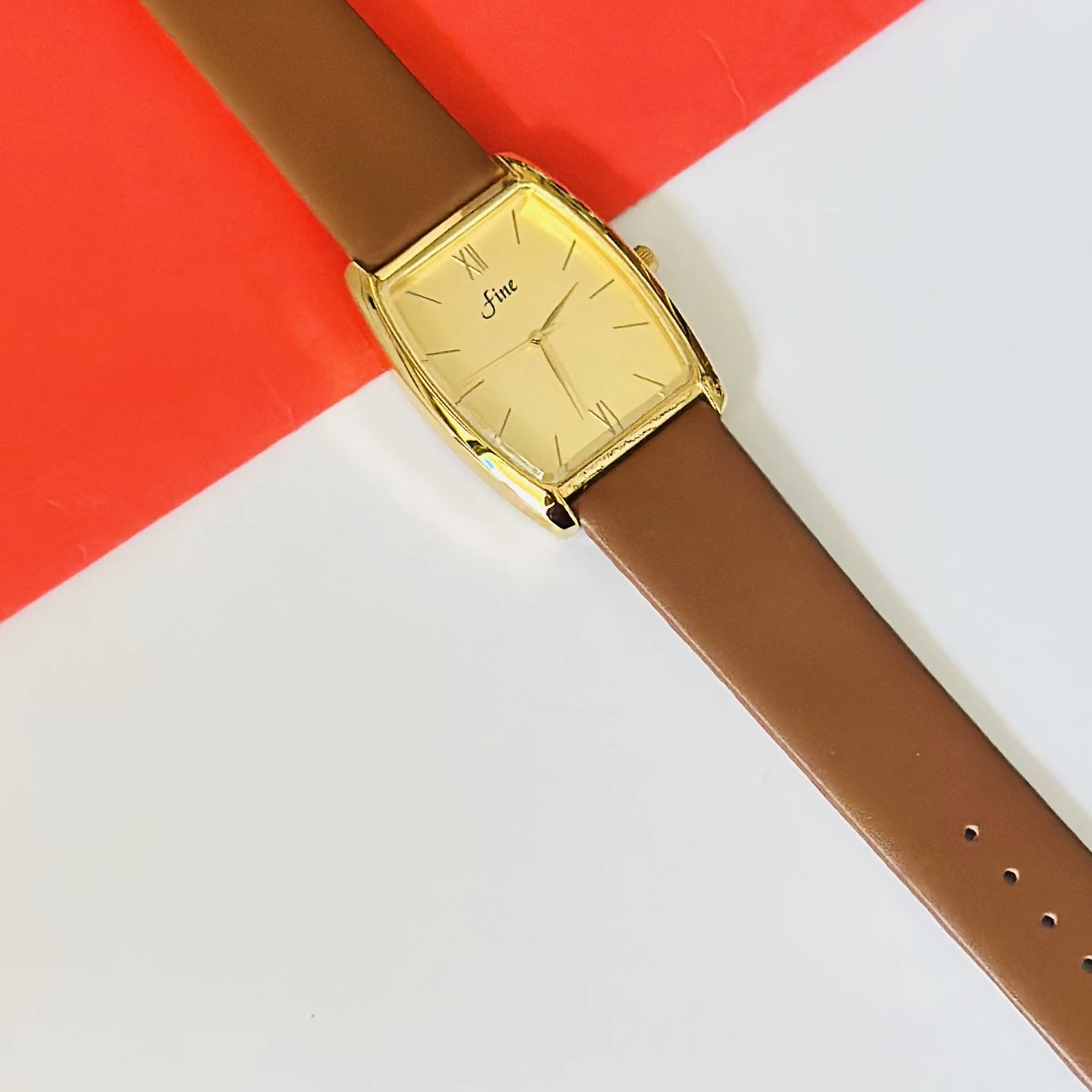 Gold toned GEDI women's quartz watch with a brown leather strap.
