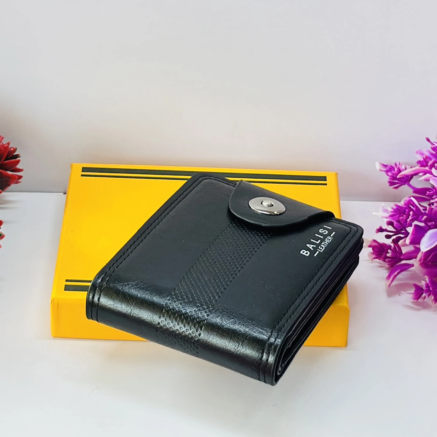 Black "Balisi" men's leather wallet with a button closure.
