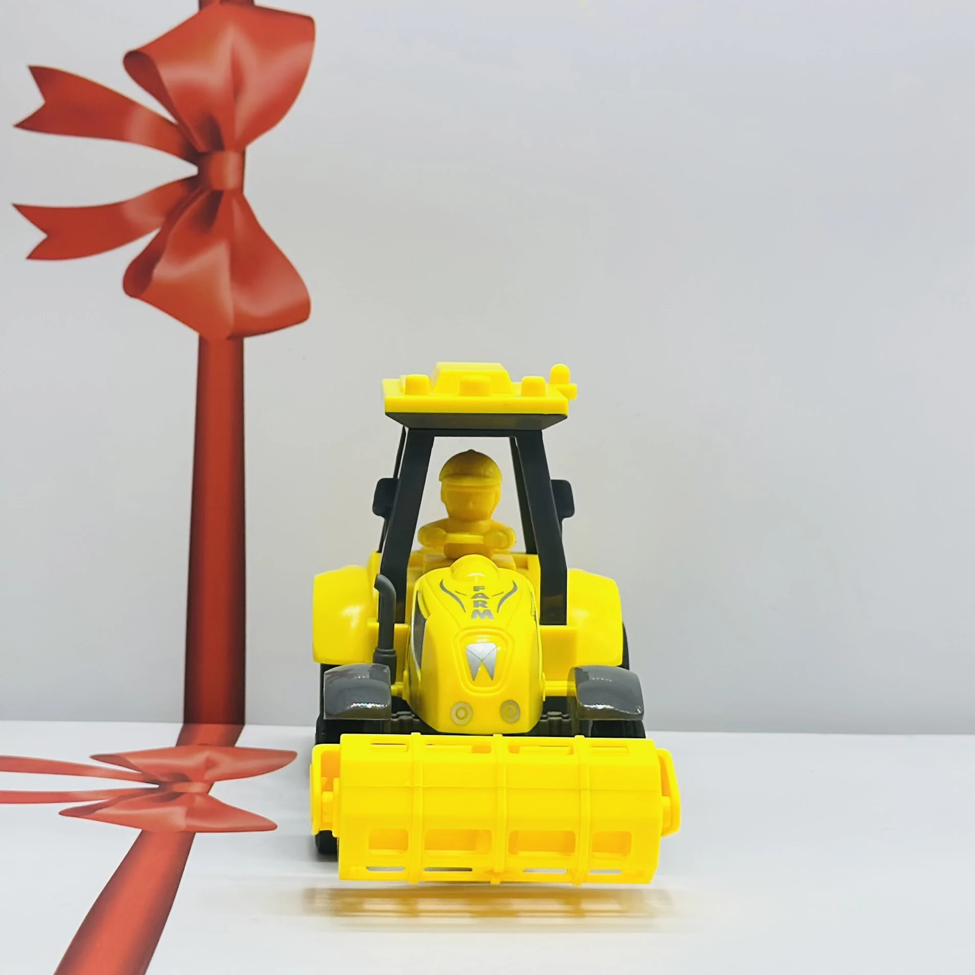 Yellow plastic toy tractor