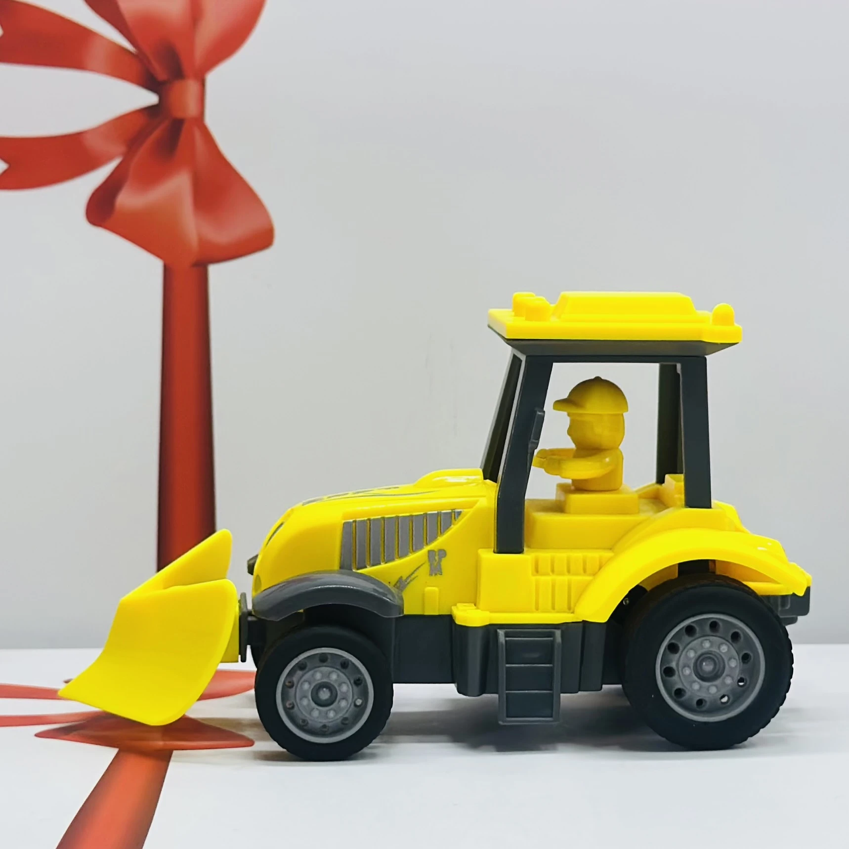 Yellow plastic toy tractor