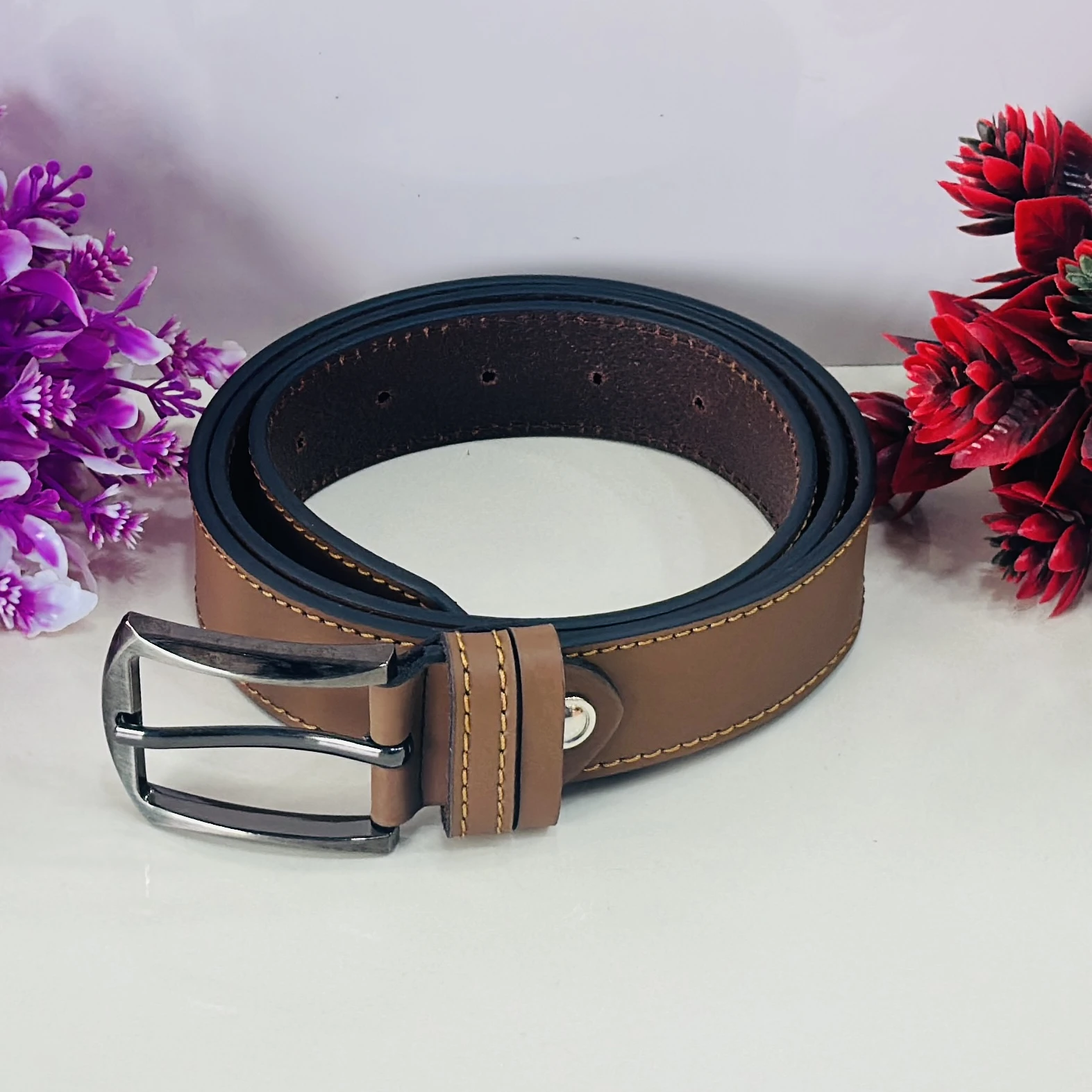 Brown leather belt with a metal buckle