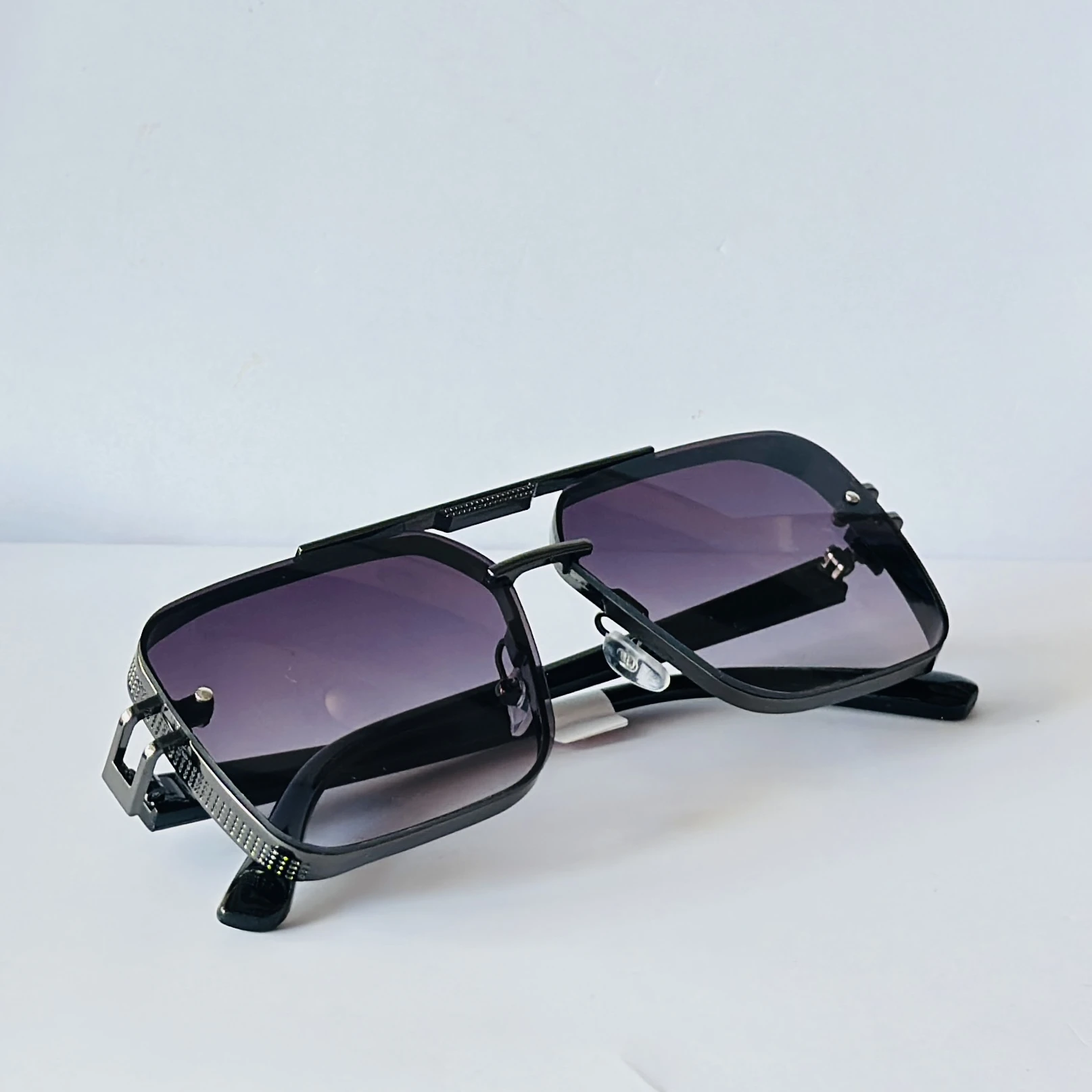 appear to be retro square or modern pilot-style sunglasses for men