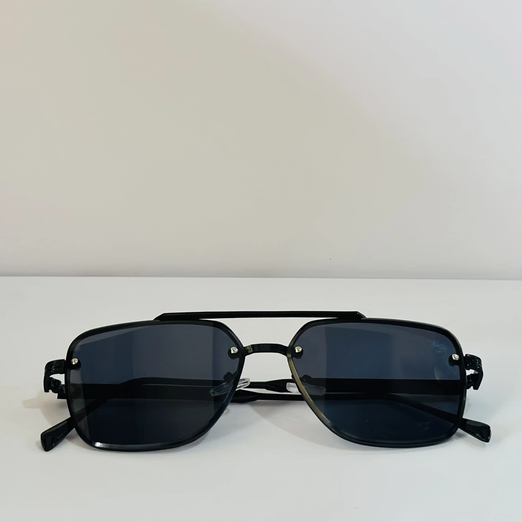 pair of MOONX Celebrity black UV protected sunglasses with a black frame.