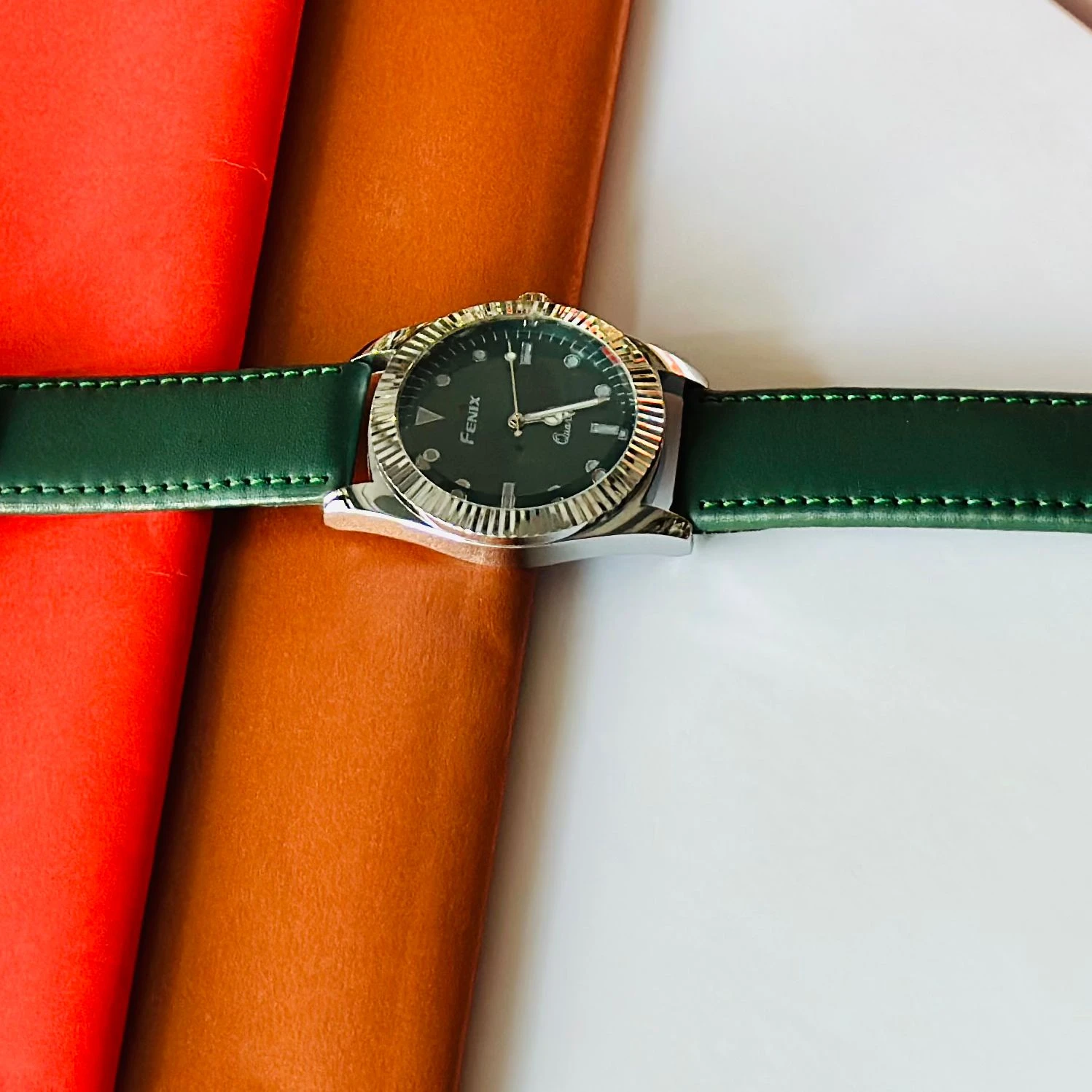 Round analog watch with a Green  leather strap