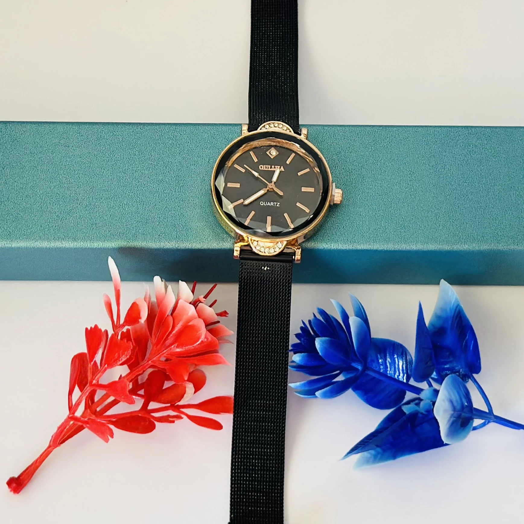women's black mesh watch with a rose gold-tone case and a crystal accent.