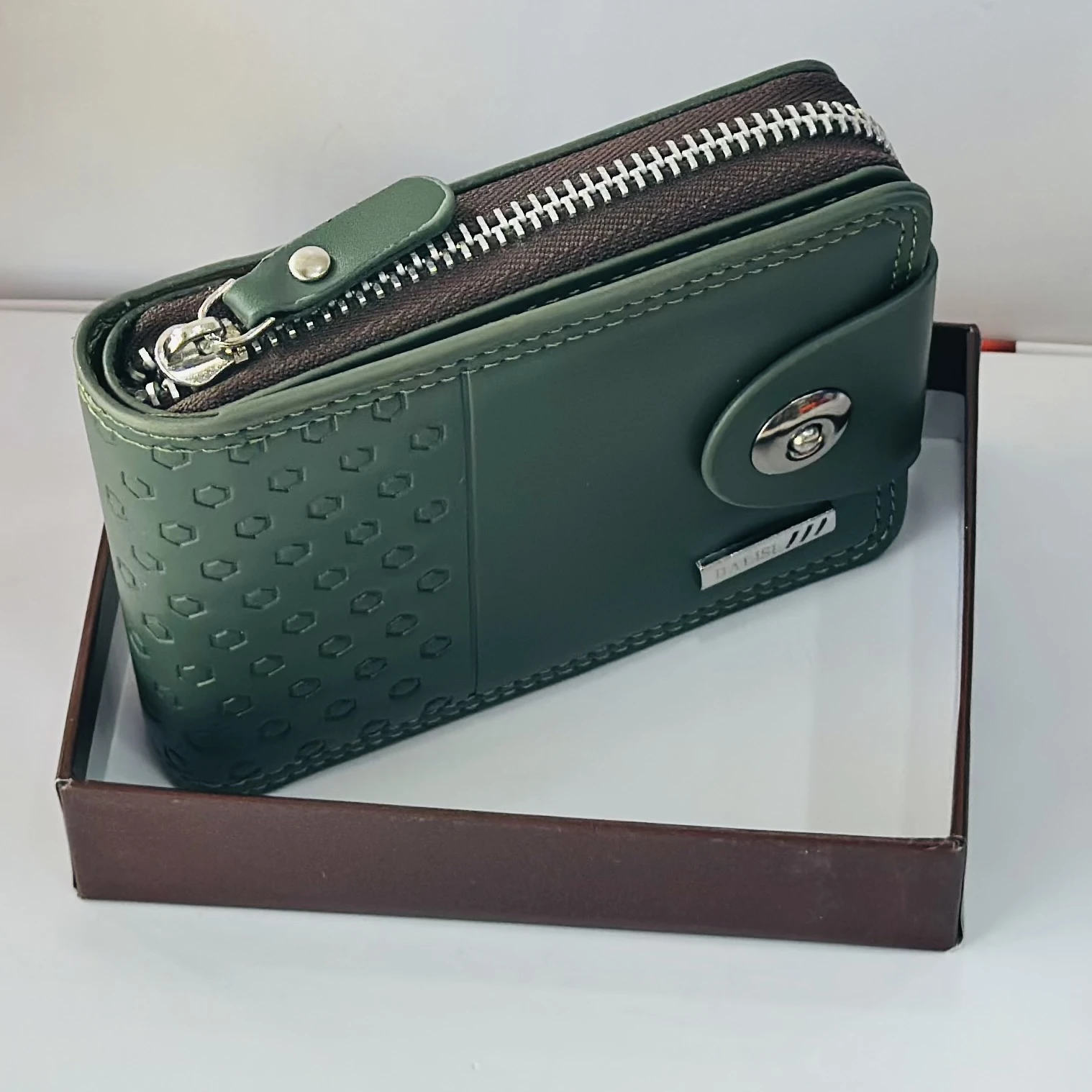 Balisi green leather wallet with a button closure.