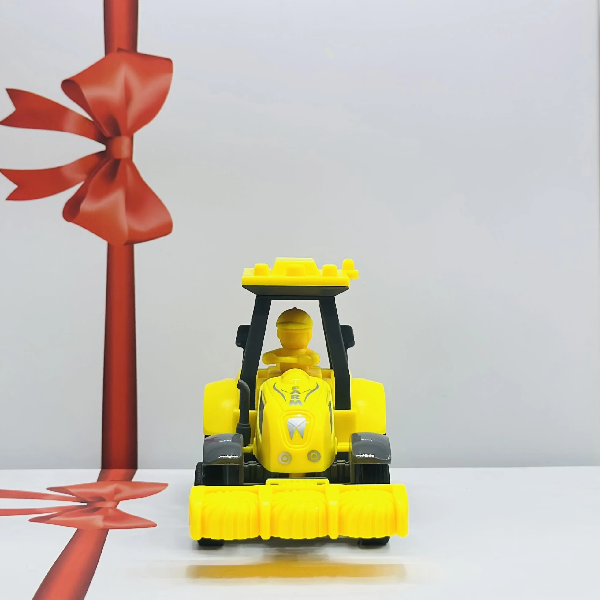 Yellow plastic toy tractor