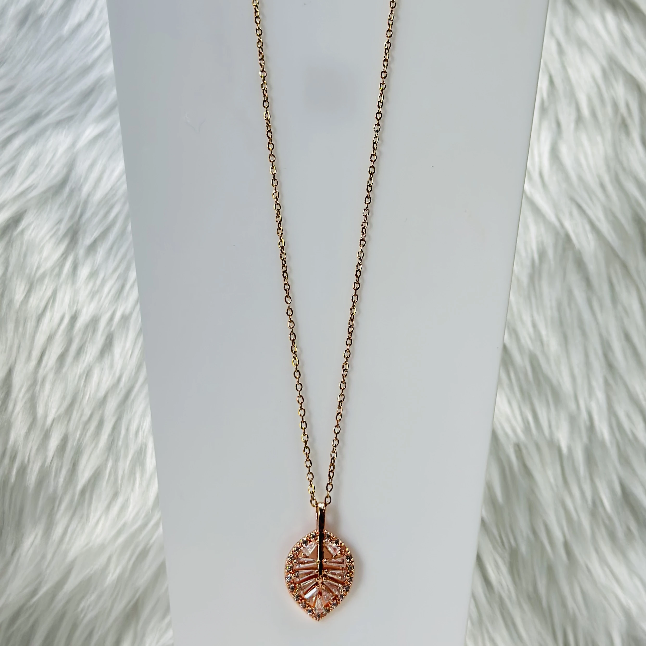 Rose gold palm leaf necklace with diamond accents, crafted from stainless steel.