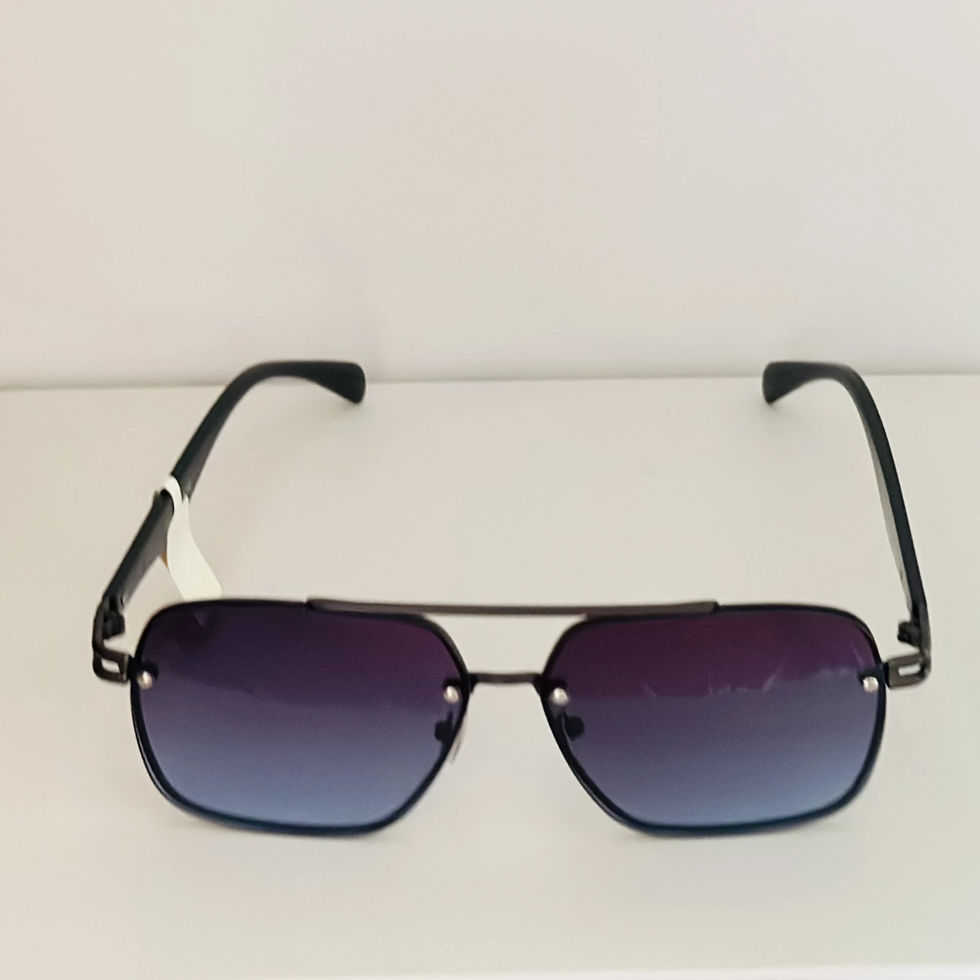 black rimless aviator sunglasses with blue gradient lenses.