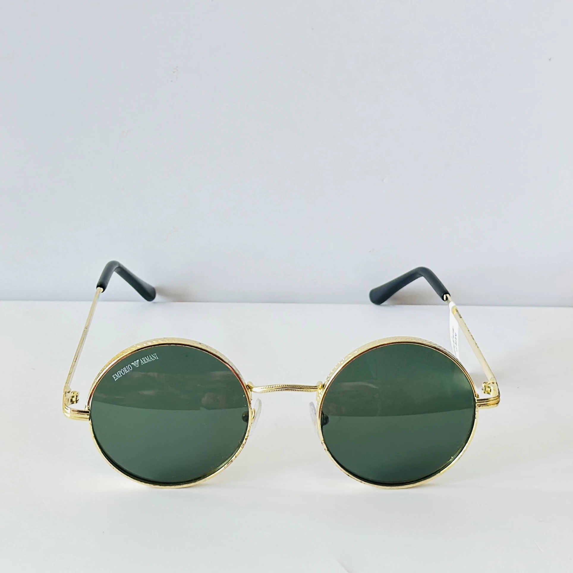 sunglasses are Emporio Armani round-frame