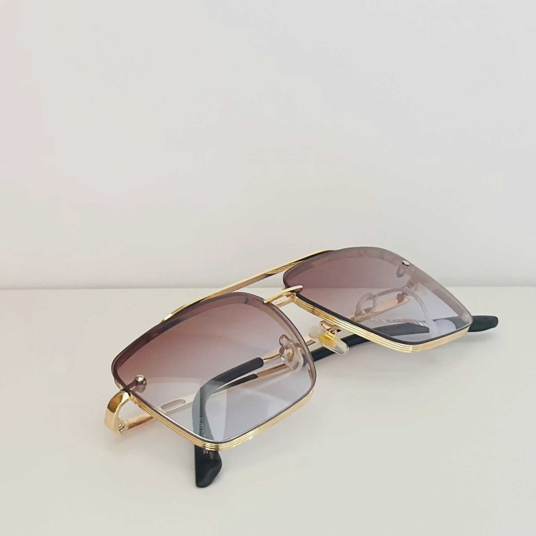 pair of DITA Mach-Six sunglasses with gold-tone frames and brown-to-clear gradient lenses