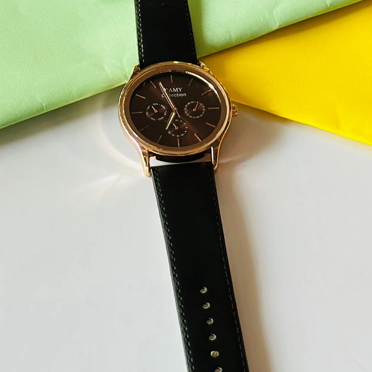Round  analog watch with a black  leather strap