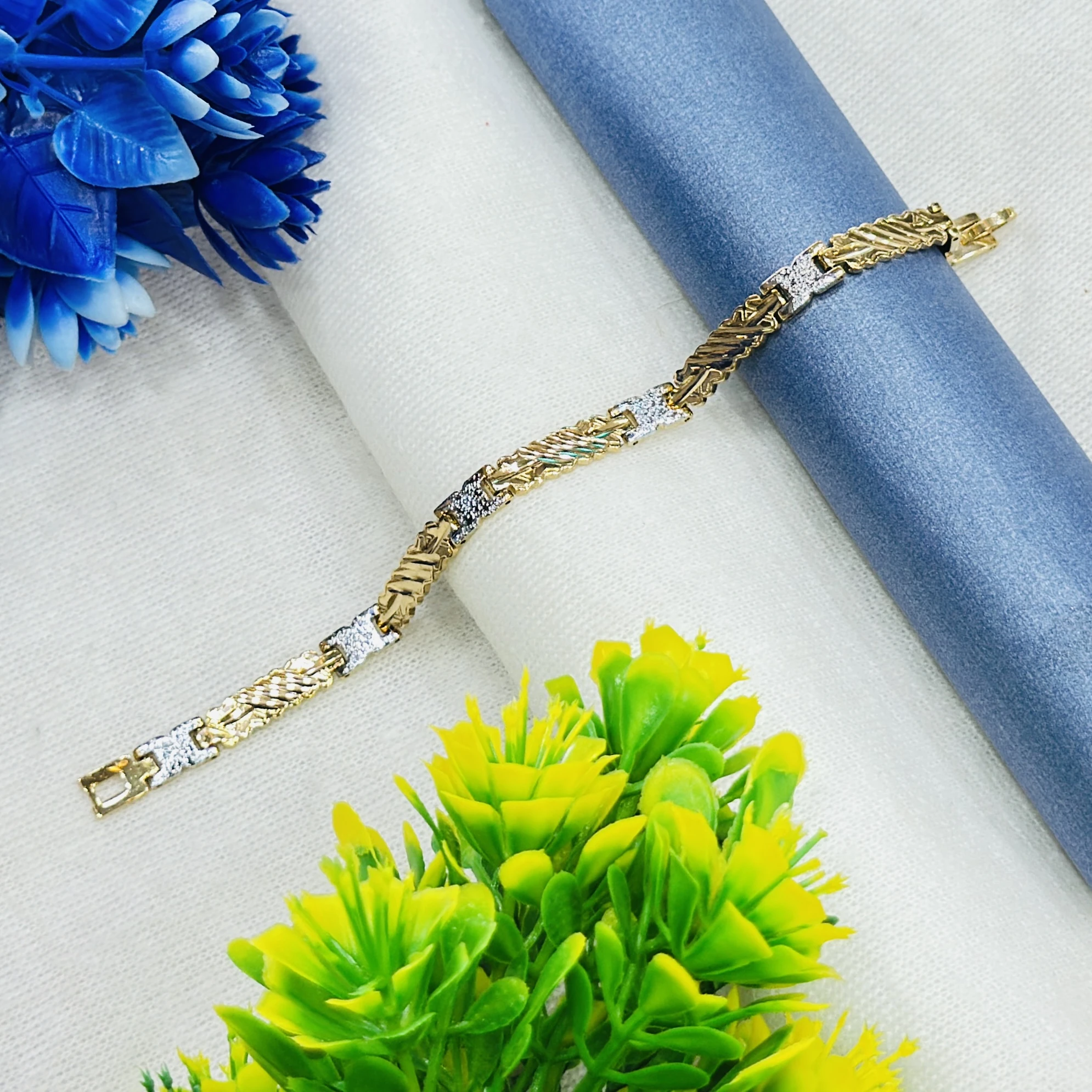 Gold plated men's bracelet featuring a textured, two-tone design.
