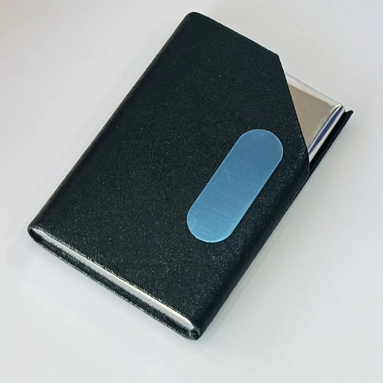 Black faux leather and metal business card holder.