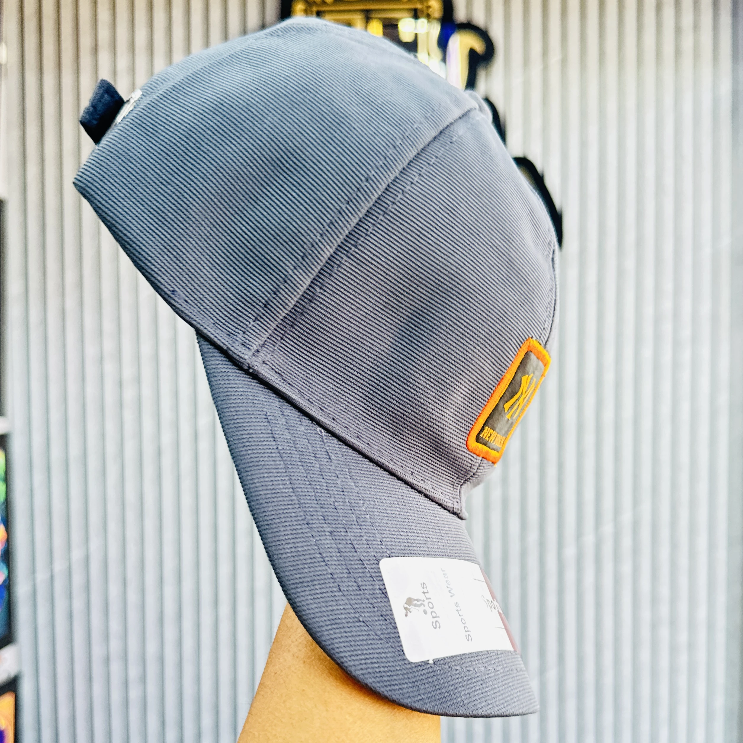 Gray baseball cap features the New York Yankees logo.