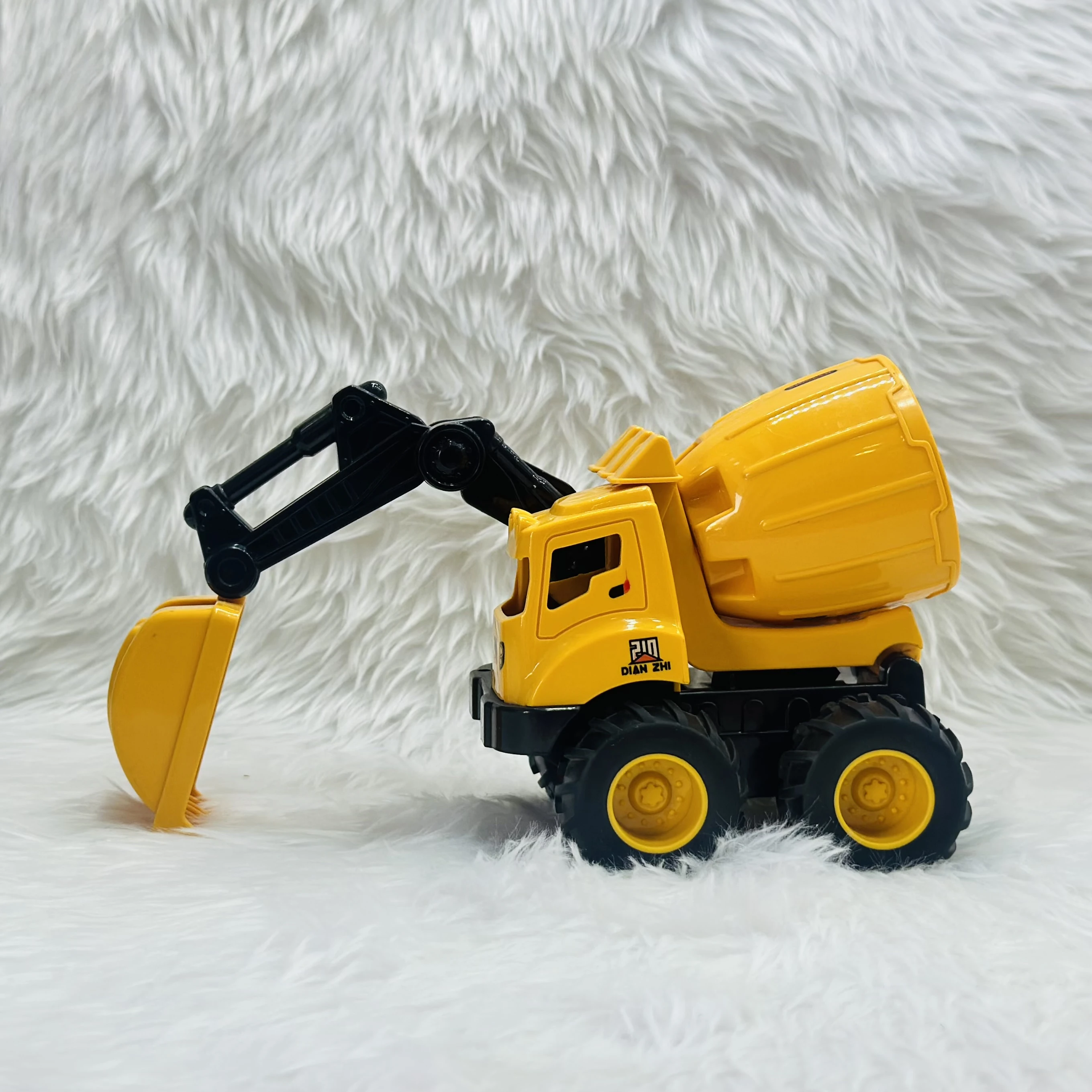 Cement mixer with an attached excavator arm.