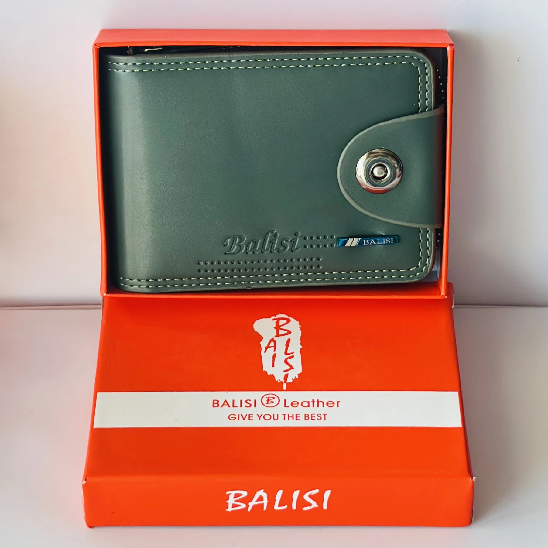 Balisi bifold leather wallet in green with a button closure.