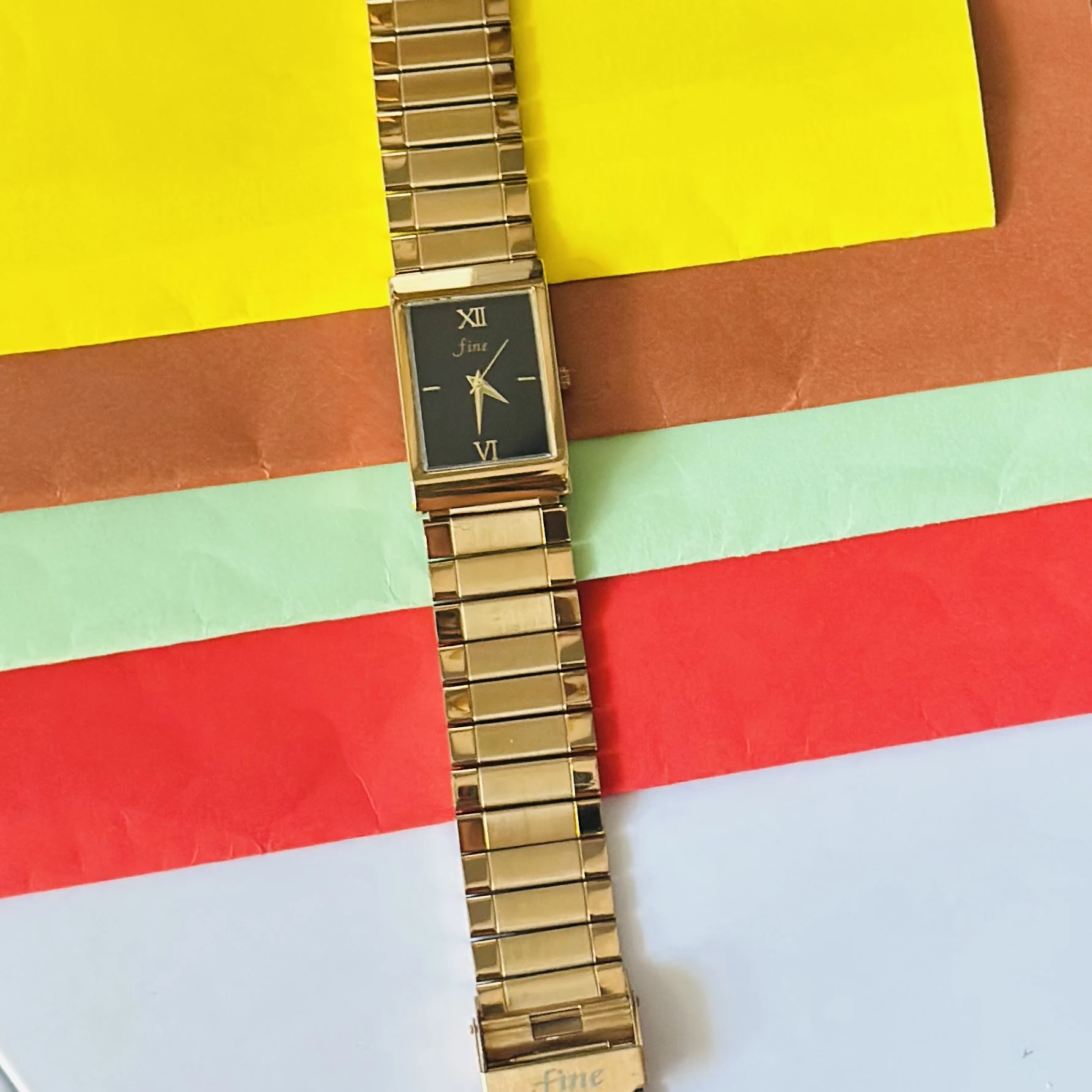 Gold -tone analog quartz watch with a metal strap.