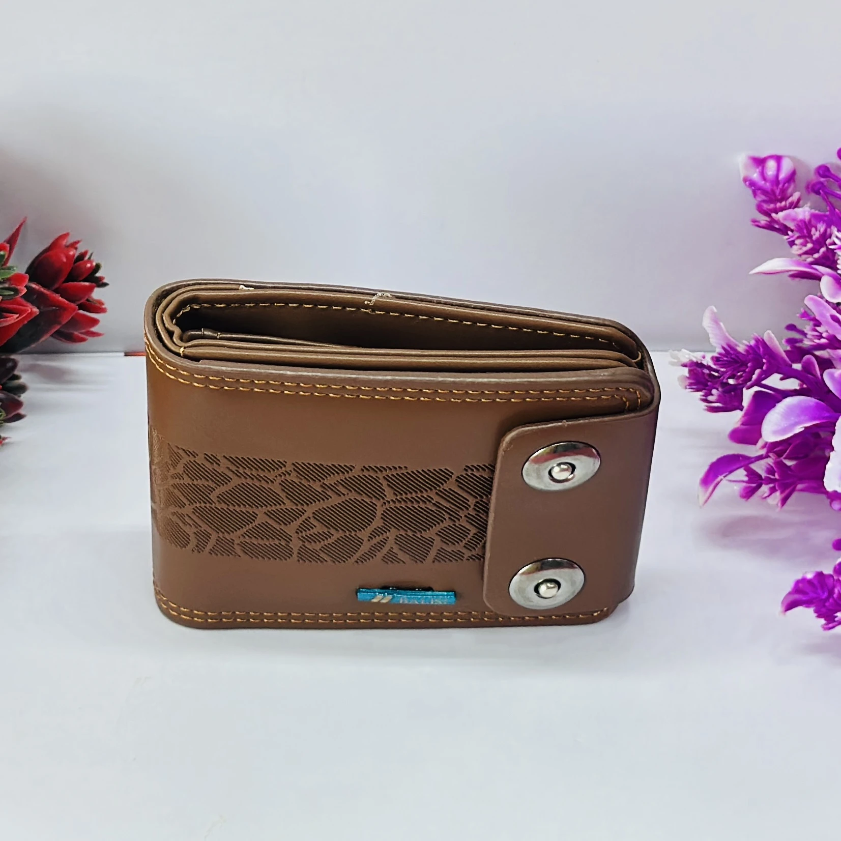 brown men's BALISI wallet with a textured pattern and snap closure.