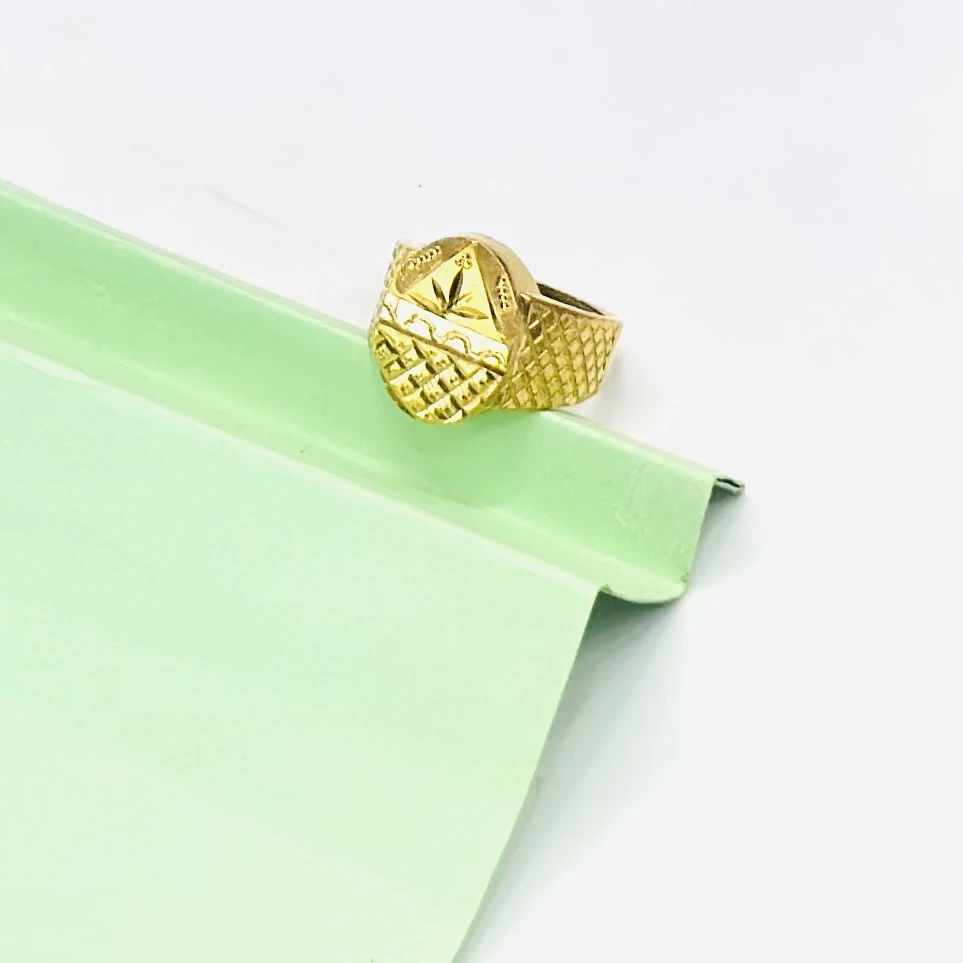 Gold plated men's ring with a cross design.