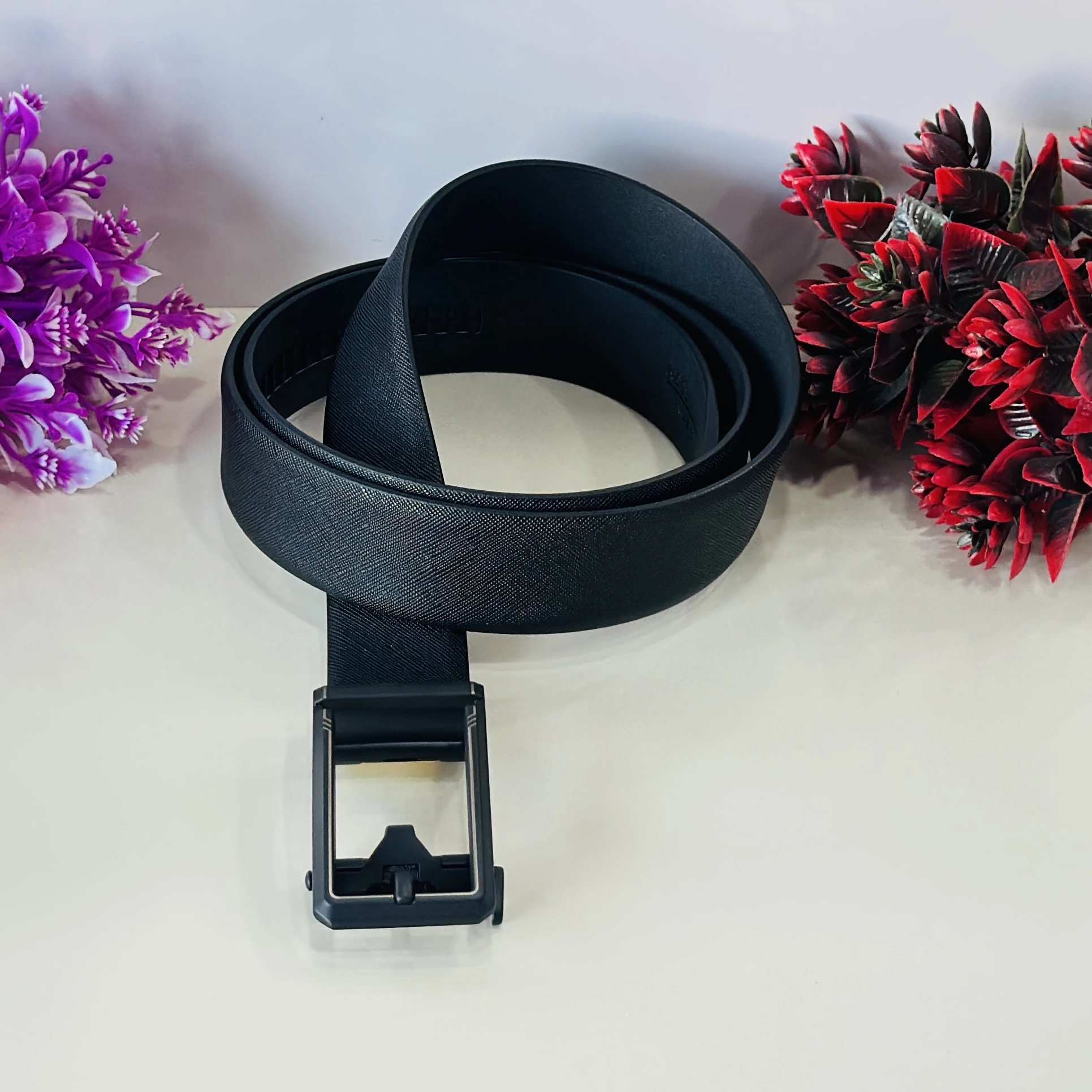 Black Saffiano leather reversible belt with a gunmetal buckle.