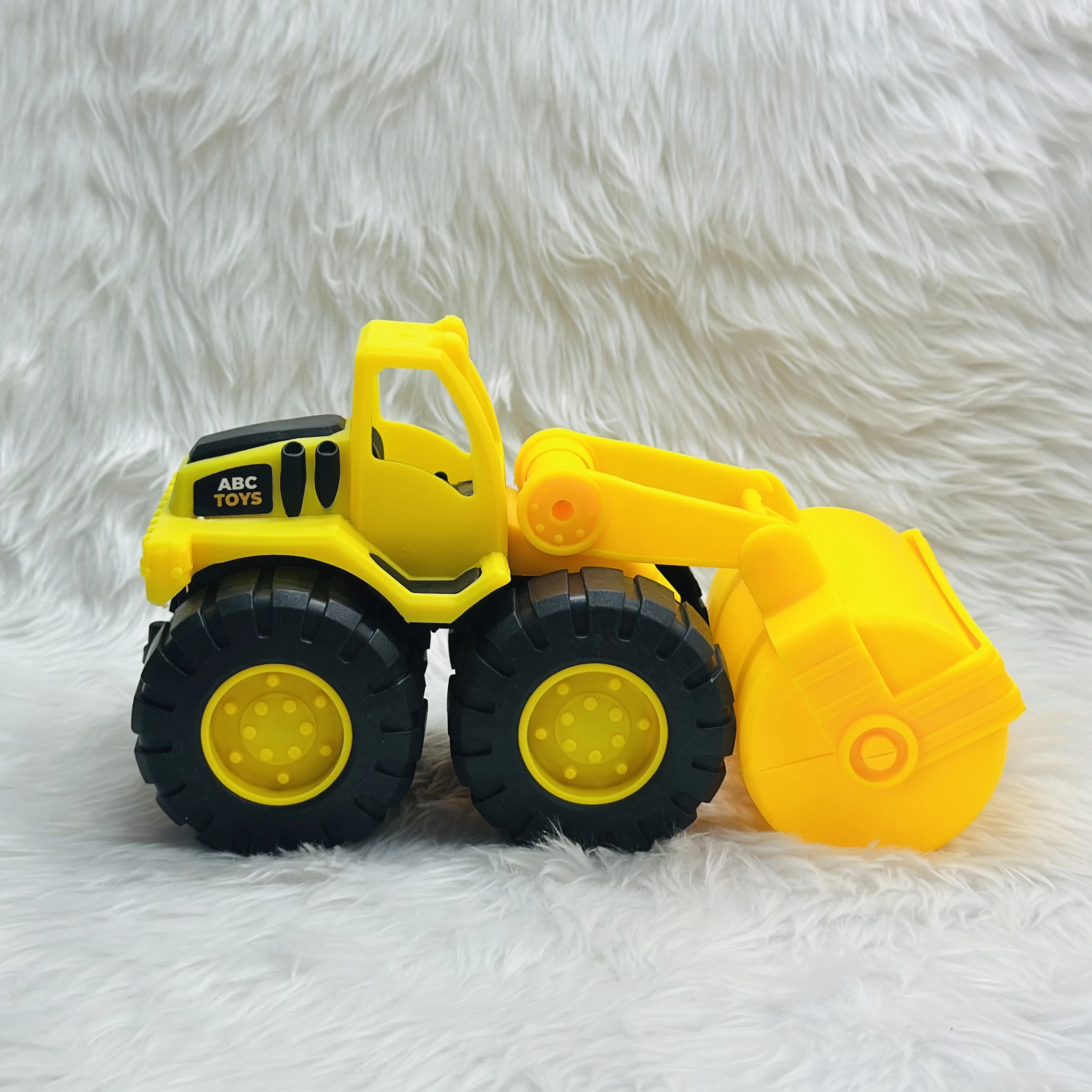 yellow toy construction vehicle, identified as a bulldozer or wheel loader,