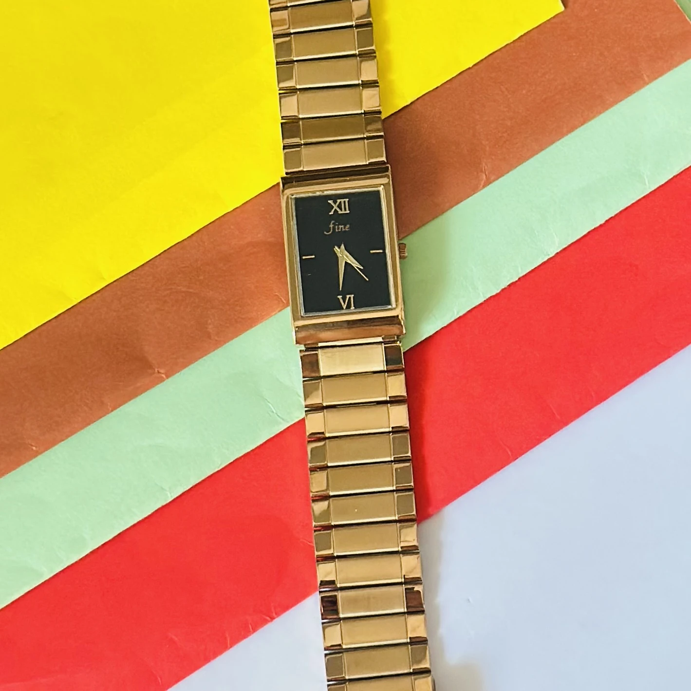 Gold -tone analog quartz watch with a metal strap.