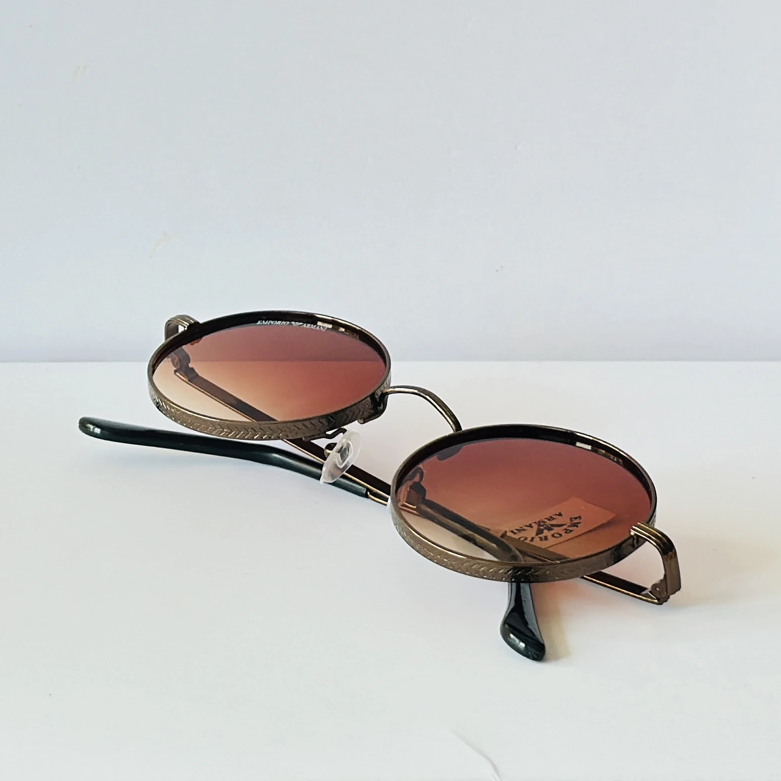 sunglasses are Emporio Armani round-frame