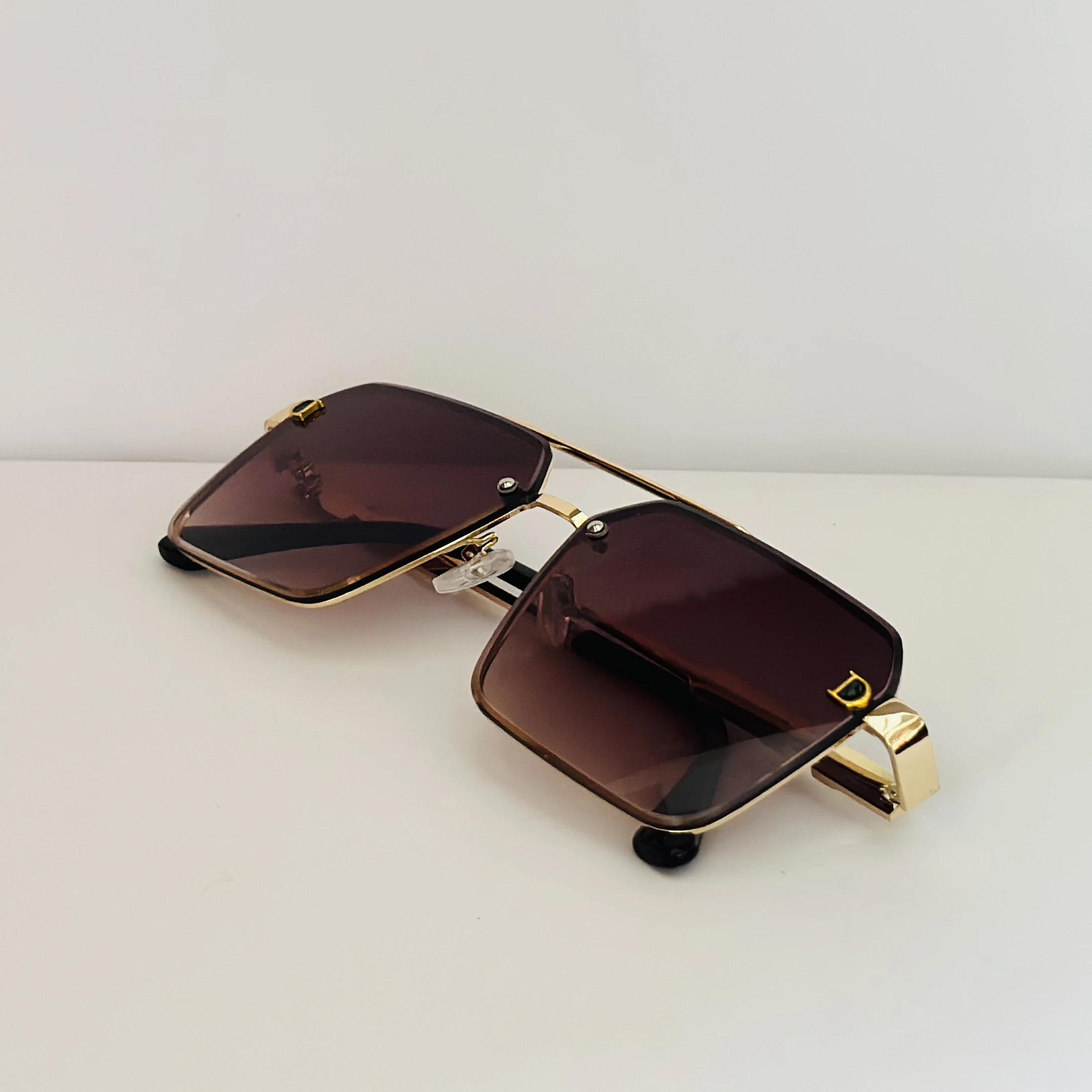 Gold Frame brown gradient lens oversized square sunglasses with black temple arms.