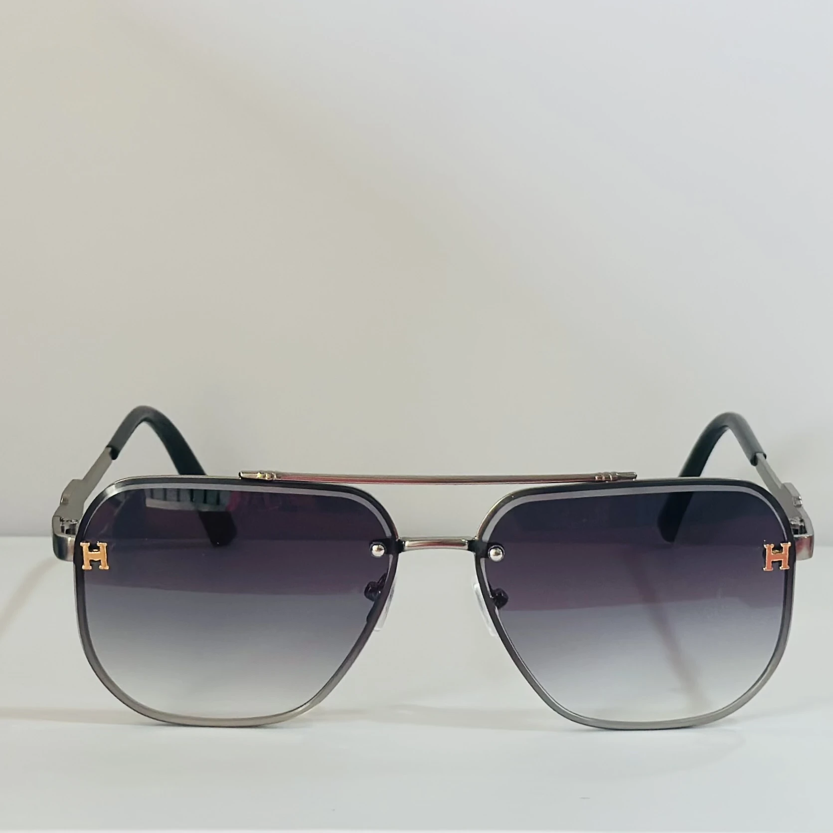 pair of Maybach aviator sunglasses with black and gold details.