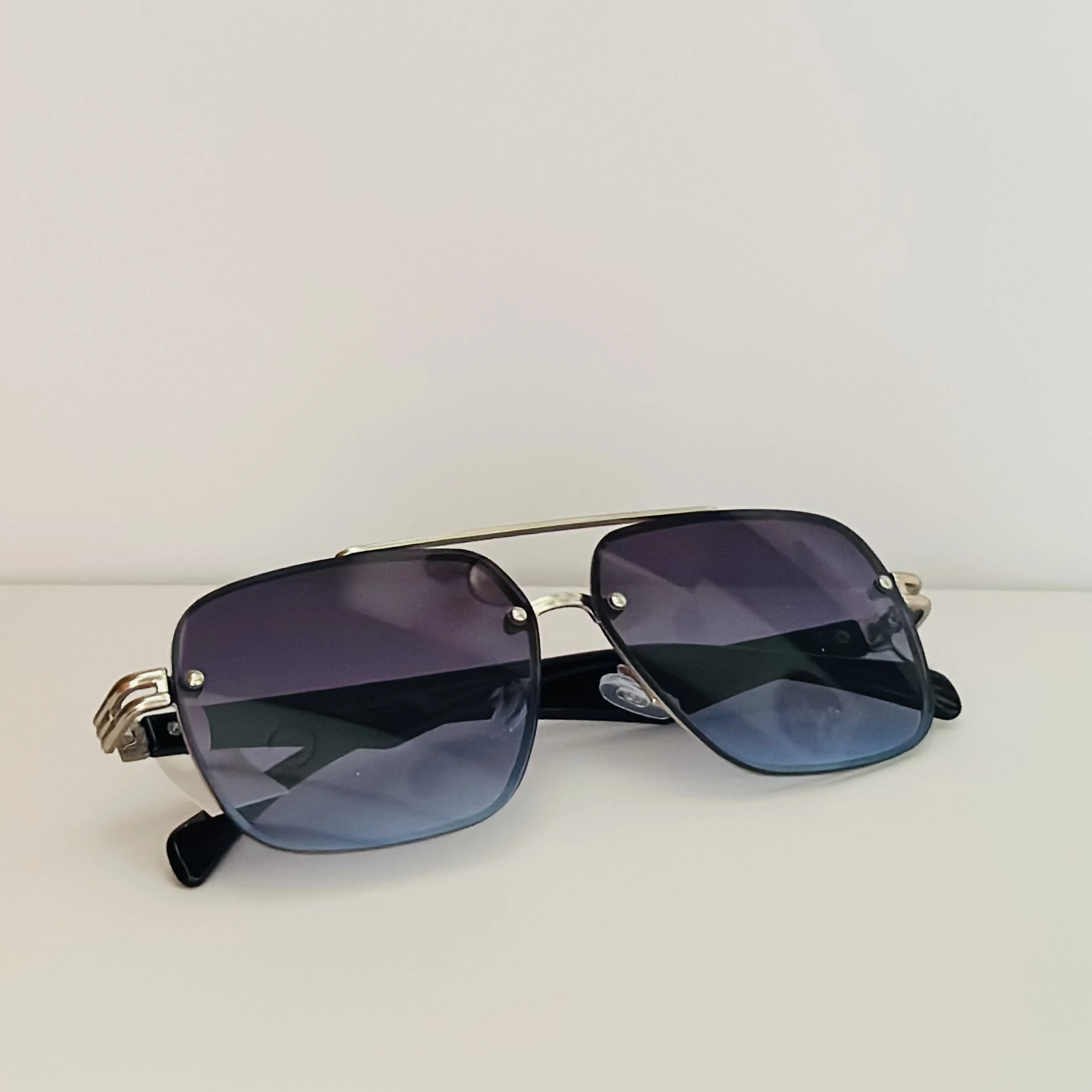 GOGLASSIC GG2317 rectangle sunglasses featuring a silver-tone metal frame and blue gradient UV-protected lenses.