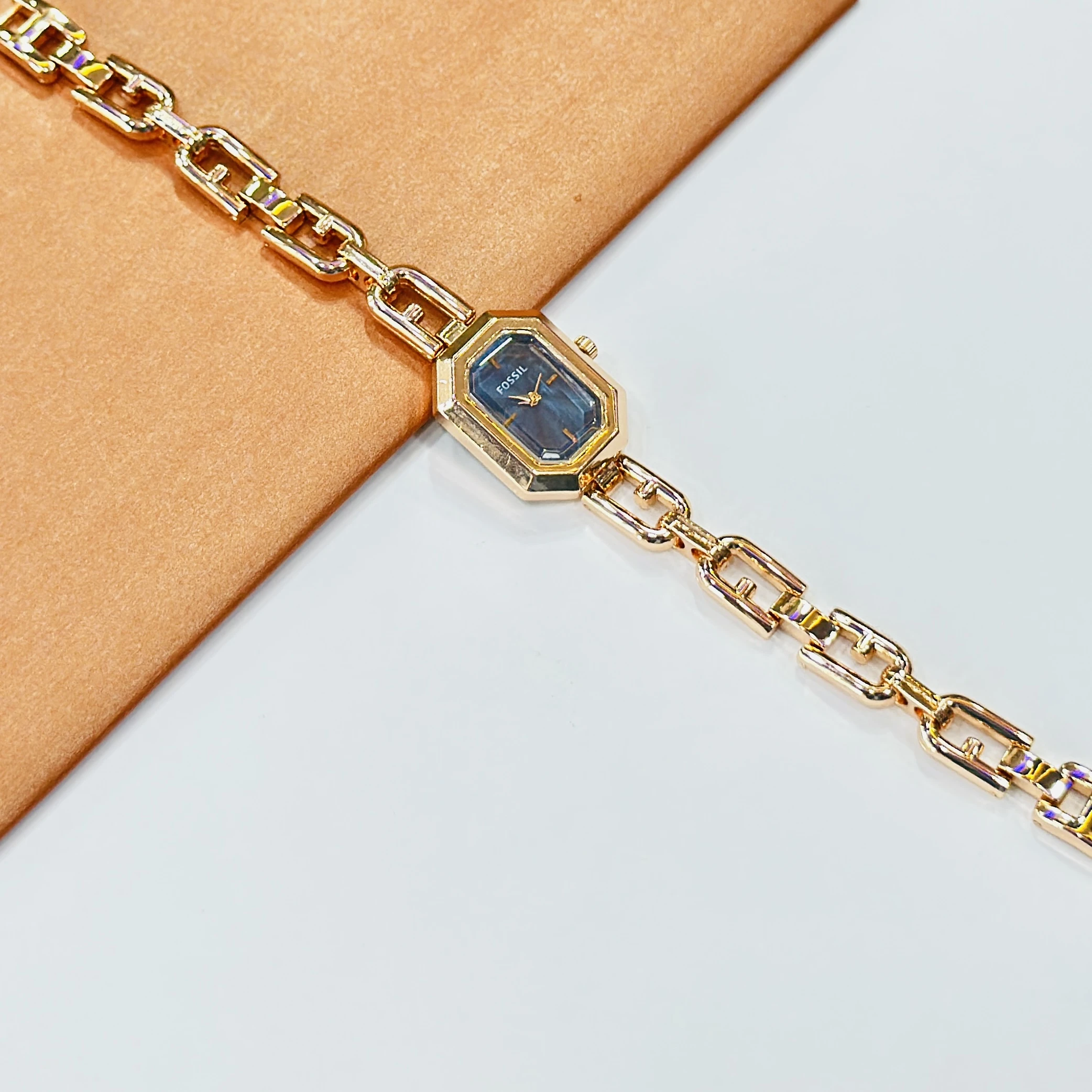 Fossil Harlow chain bracelet watch with a blue dial.
