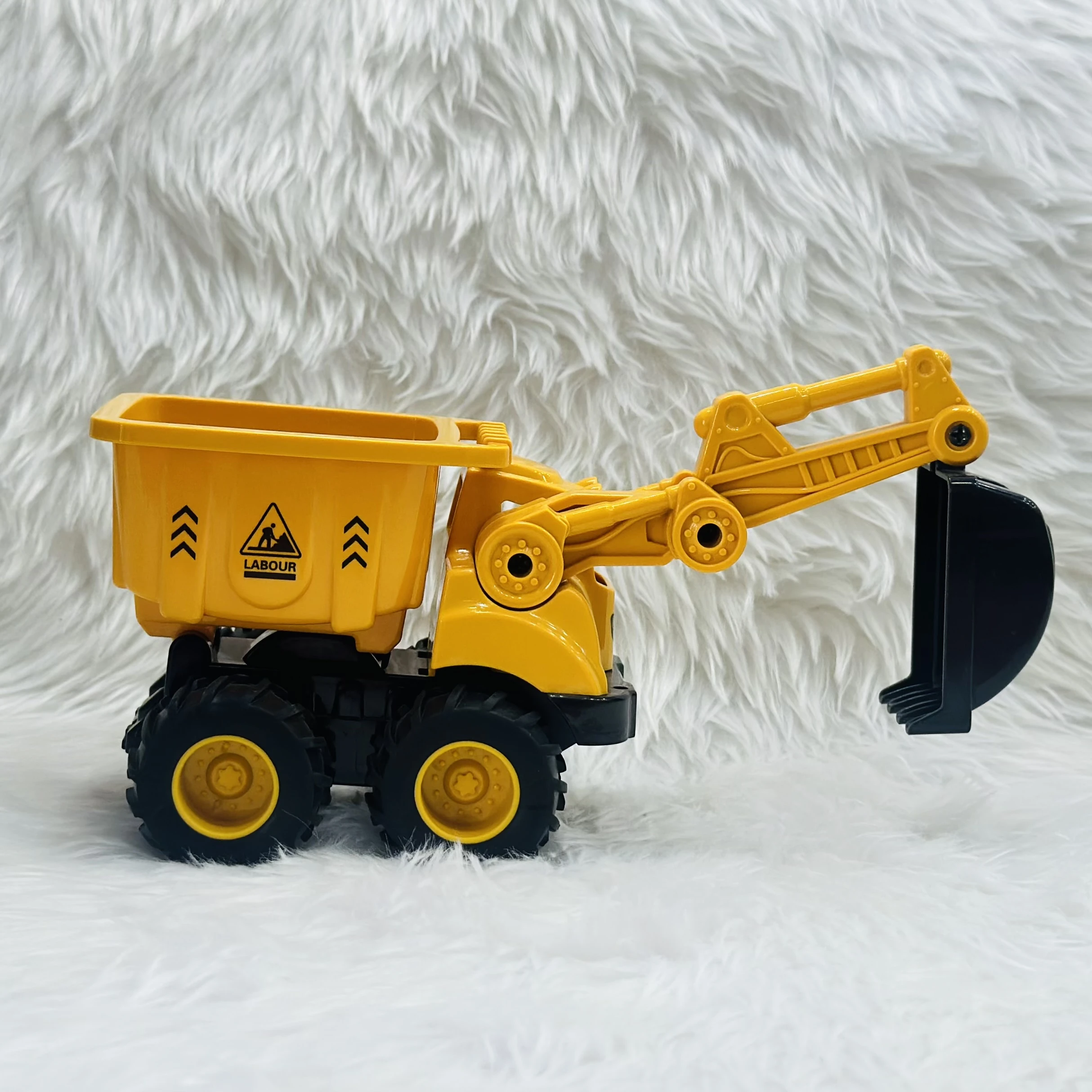 Yellow plastic toy construction vehicle, specifically a 2-in-1 friction-powered dumper and excavator truck.