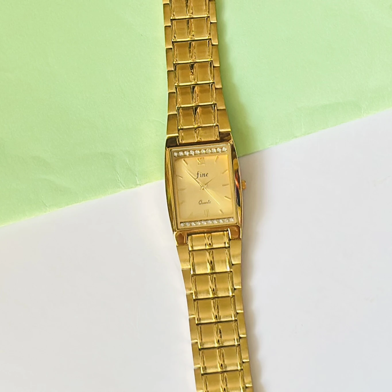 Gold plated stainless steel analog quartz watch.