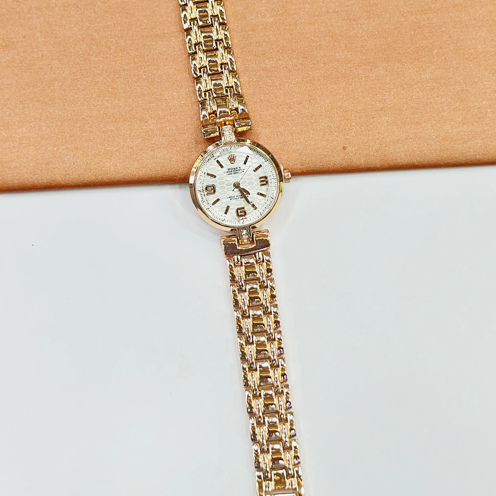 gold-tone ladies' watches with a sparkling bezel and metallic strap