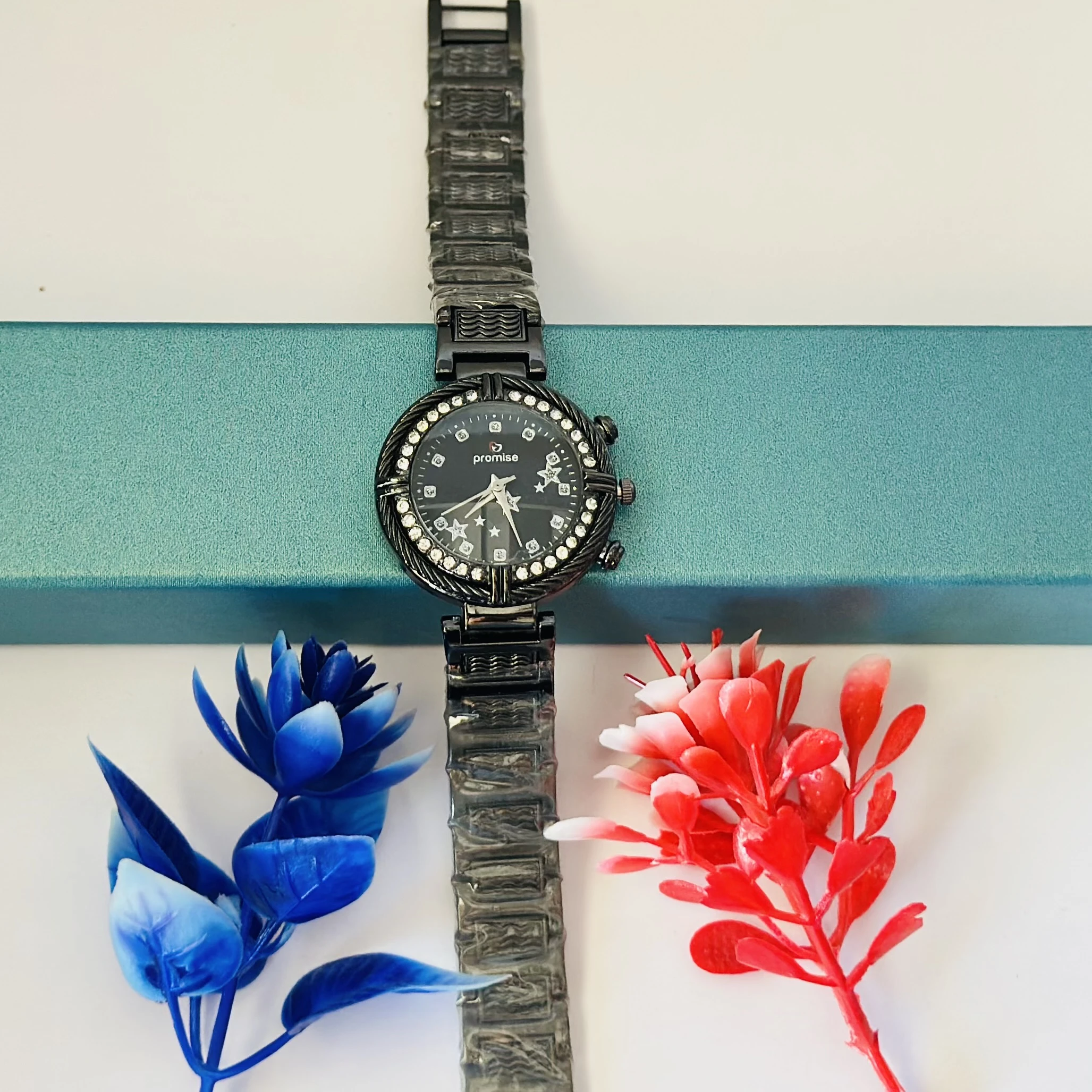 Ladies fashion watch with a black metal strap.