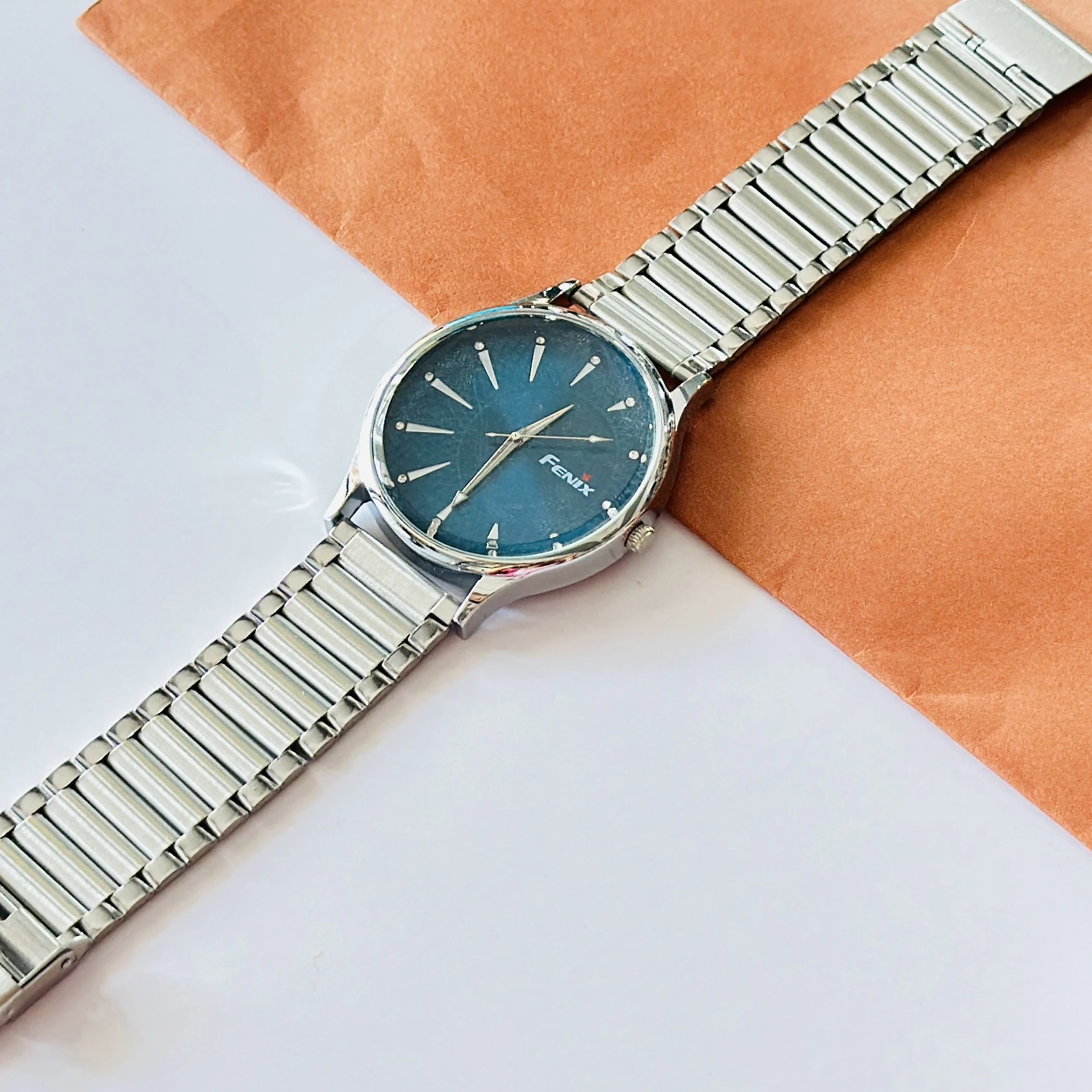 Blue dial with stick indices and a silver-toned stainless steel strap