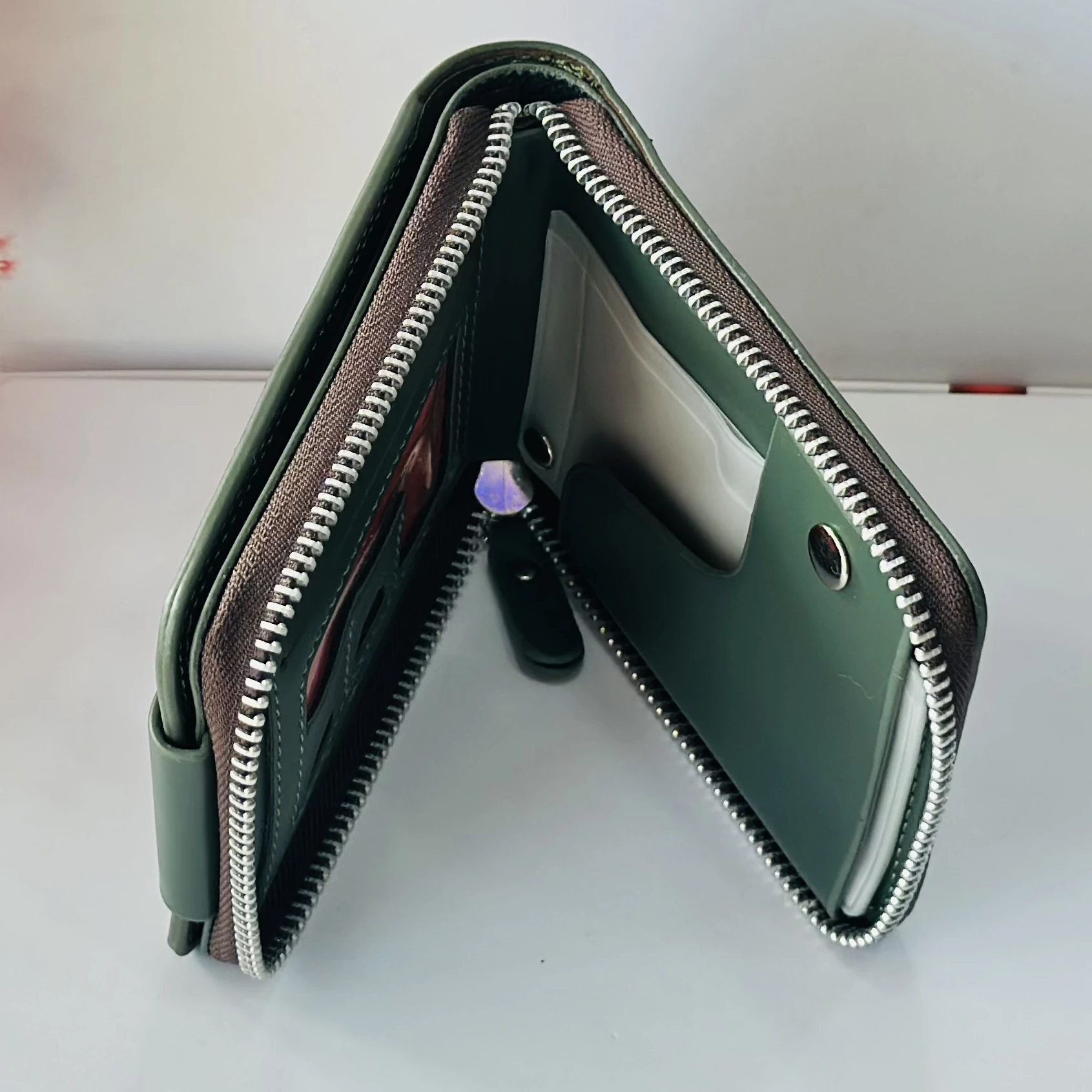 Balisi green leather wallet with a button closure.