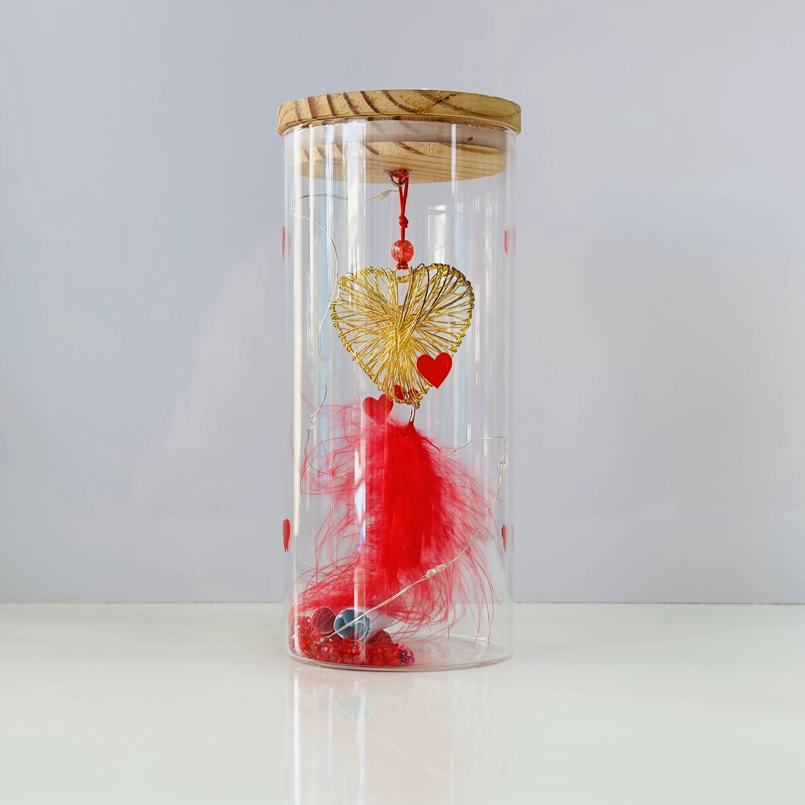 glass light with a wire heart, red feathers, and LED fairy lights. (SKU-86EZEW)
