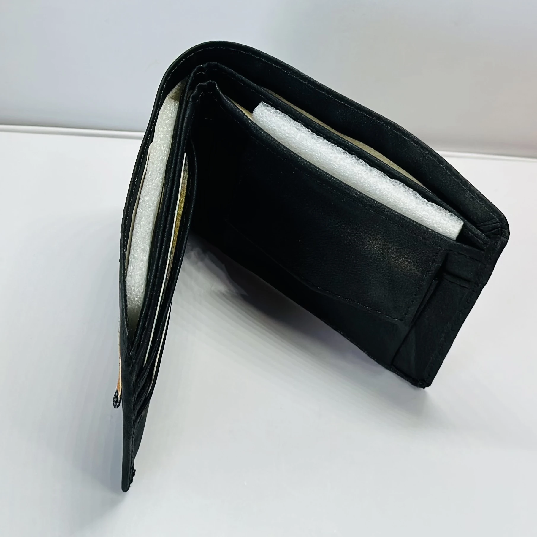 Tommy Hilfiger men's black leather bi-fold wallet.