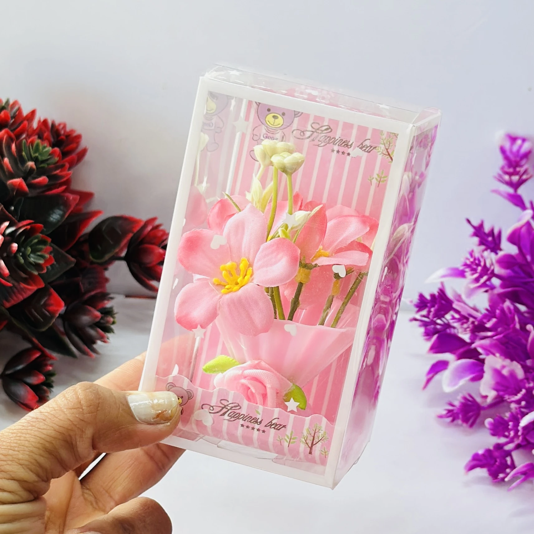 Set of artificial pink tulip flowers presented in a decorative gift box.