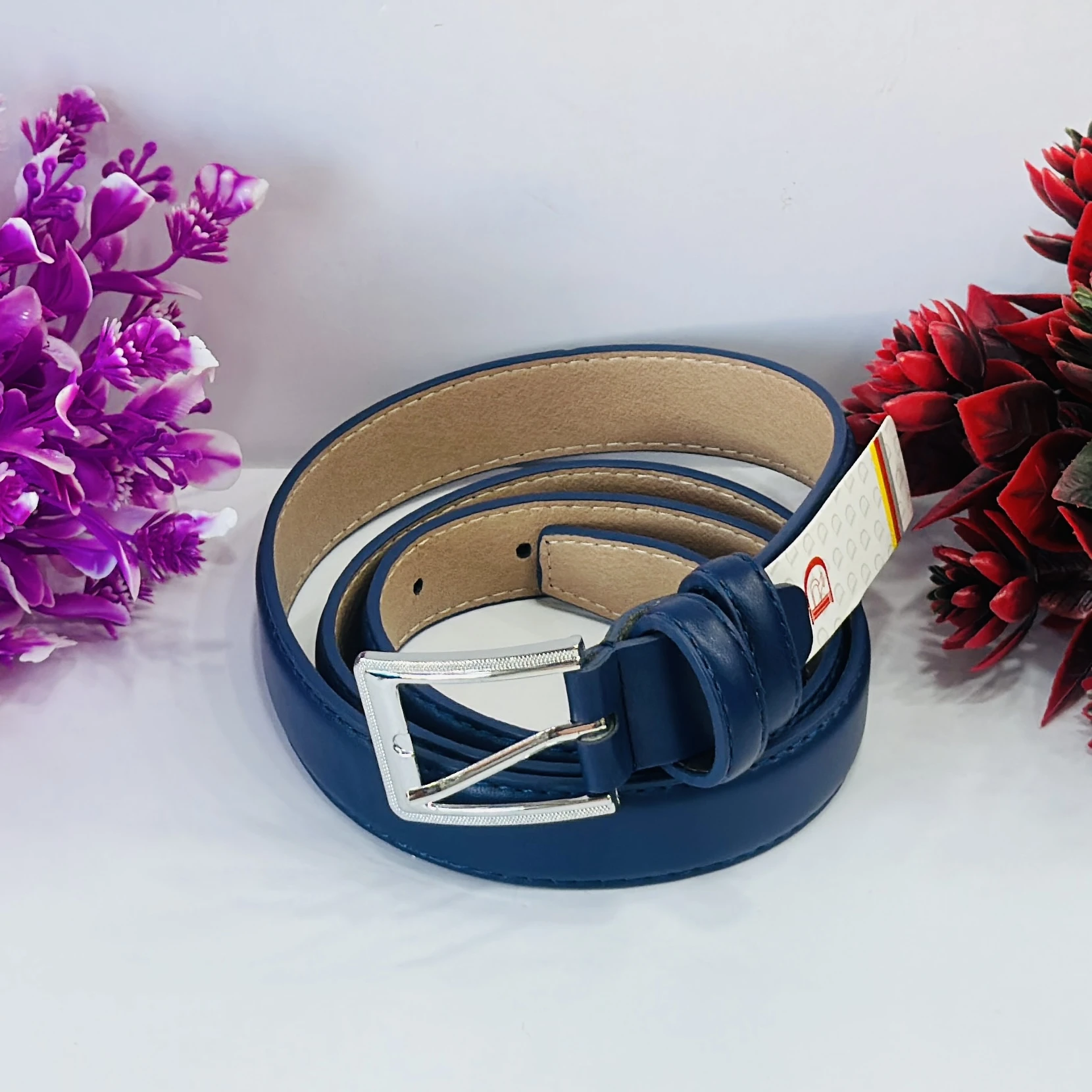 Blue leather belt with a silver-tone buckle.