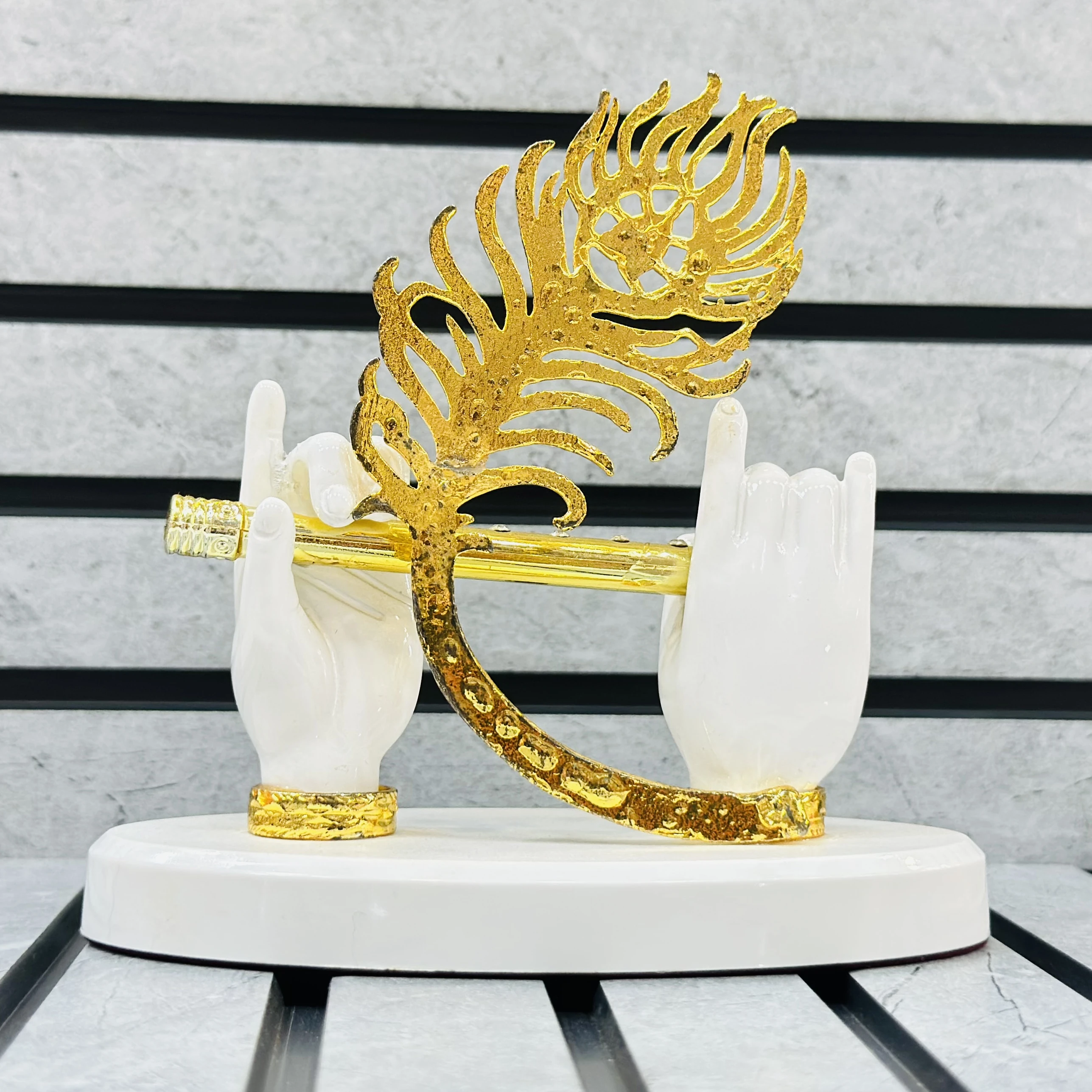 Gold gold-plated Lord Krishna hands with flute and peacock feather figurine.