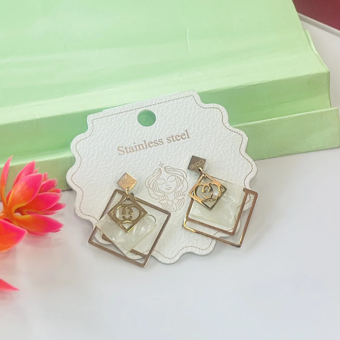 pair of anti-tarnish rose gold plated concentric chain drop earrings.